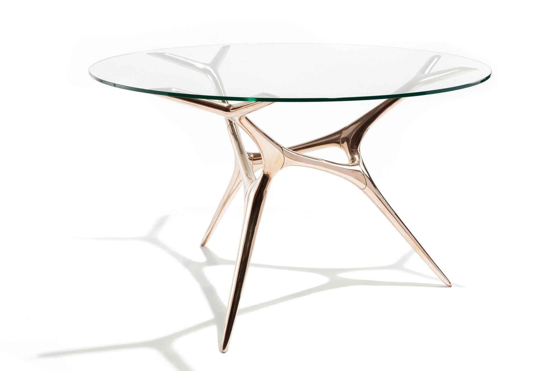 E-Volved table Timothy Schreiber
Limited editions of 25
Dimensions: aprox height of base 72 cm, fits round glass tops of 120-140 cm
Materials: Bronze, finishes polished or patina
Glass top not included

Highly driven by today’s advancements in