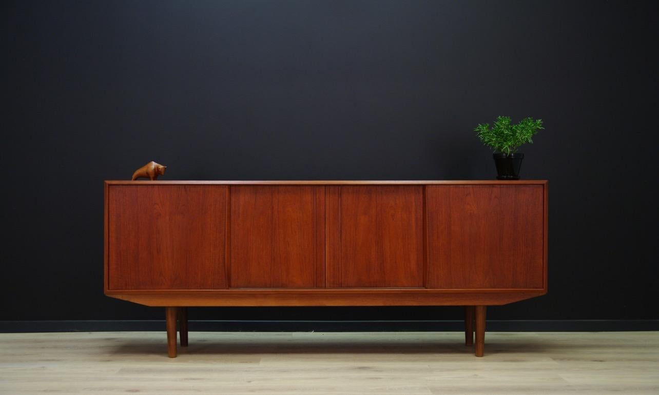 Retro sideboard, Danish minimalism from 1960-1970. Amazing form of the E.W. Bach with a spacious interior with a drawer and shelves behind the sliding door. Finished with teak veneer. Preserved in good condition (small bruises and scratches)