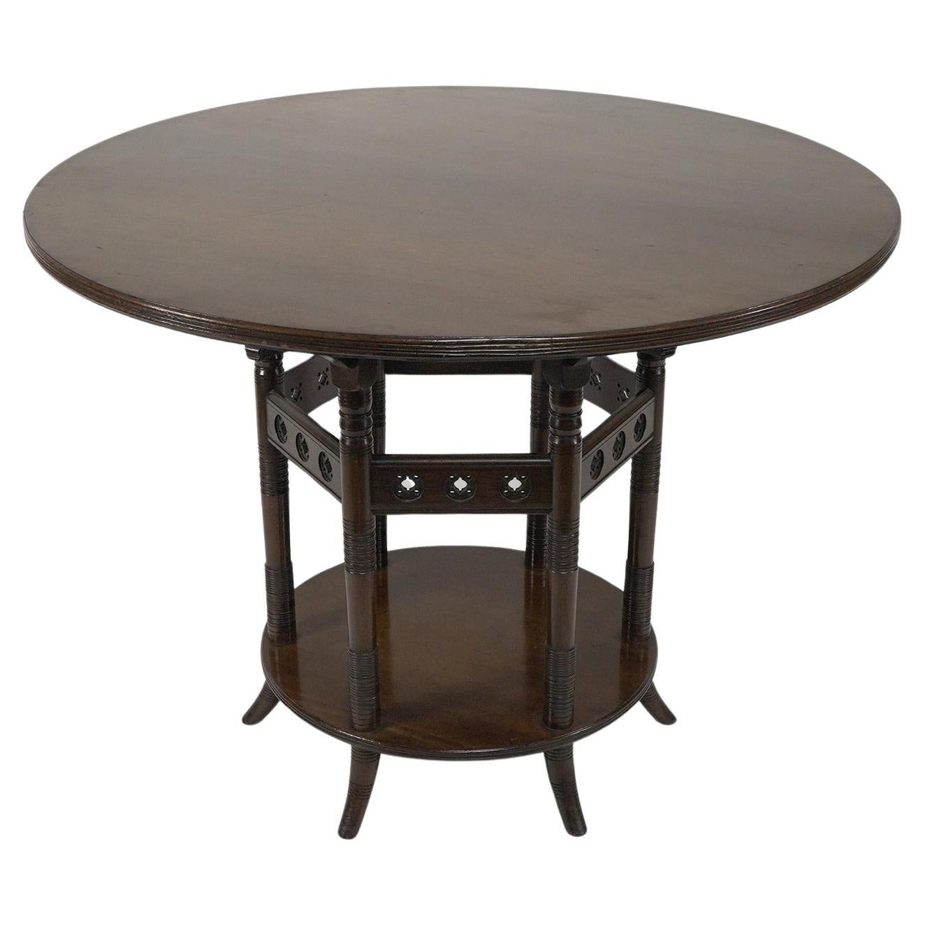E W Godwin An Aesthetic Movement six leg walnut circular centre table For Sale