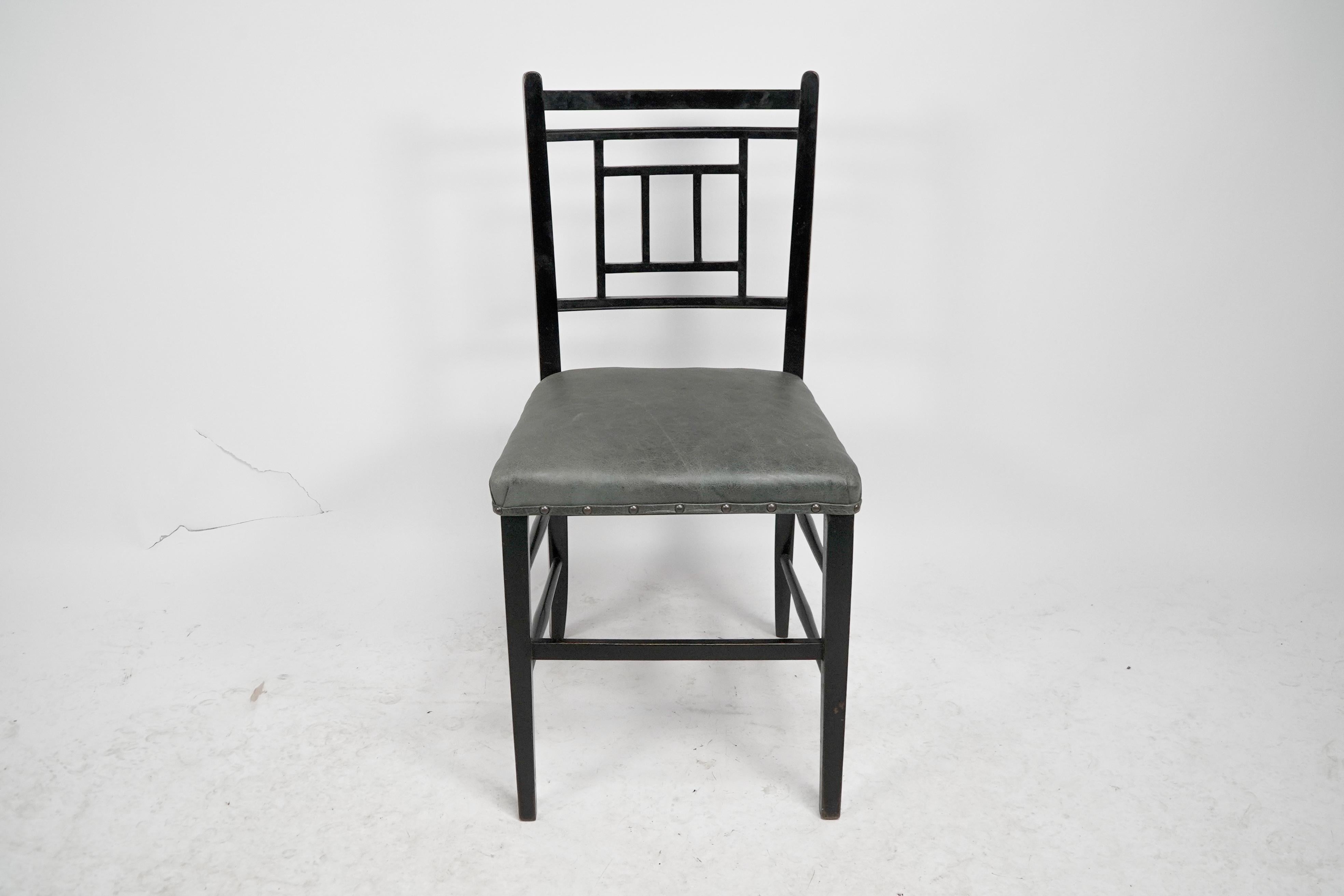 E.W. Godwin, style of An anglo japanese ebonized side chair with professionally upholstered seat in a quality hide
