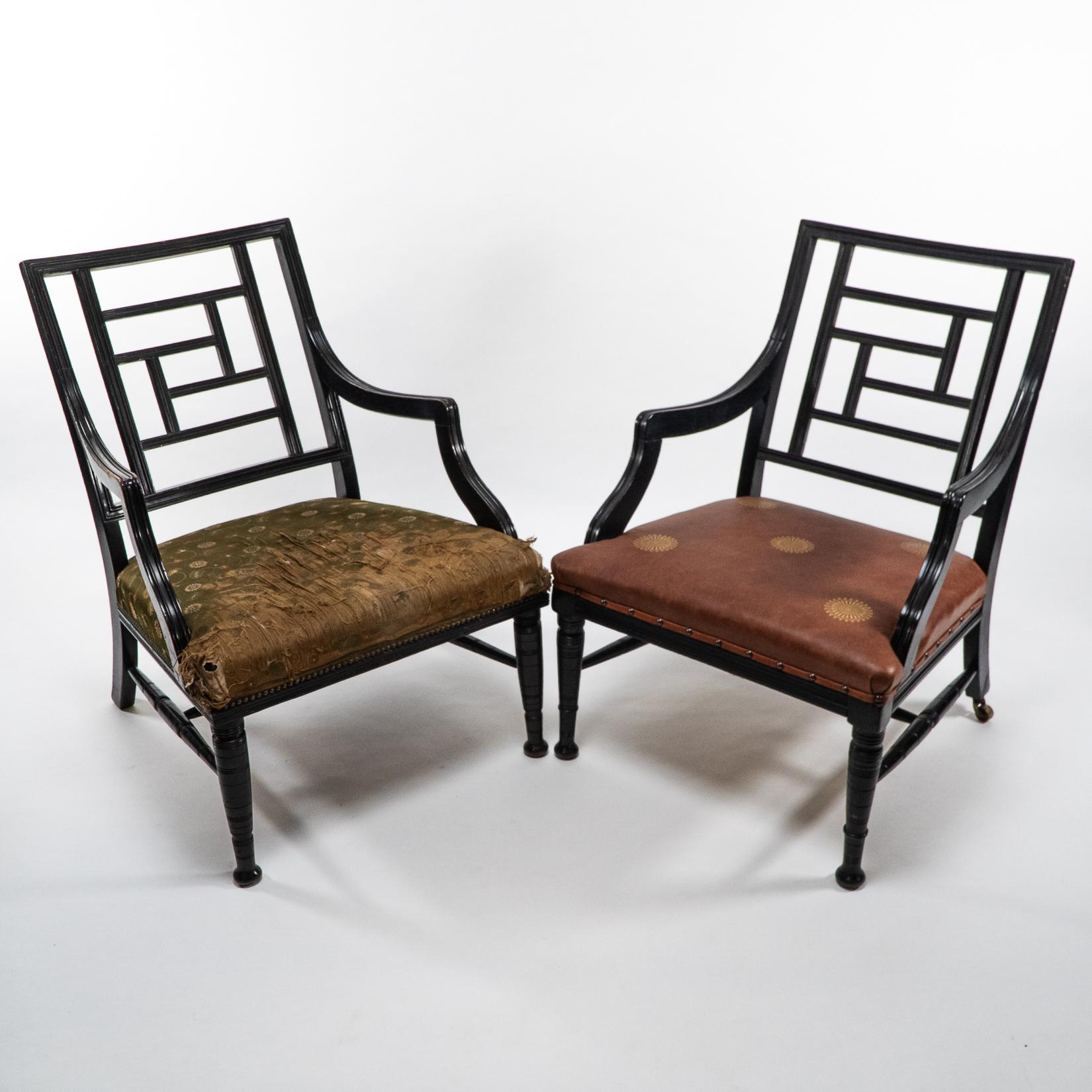E. W. Godwin attributed
Two Anglo-Japanese Aesthetic Movement ebonized armchairs. One has been professionally reupholstered with embossed gilded leather sunflower heads replicating E. W. Godwin's furniture he designed for Lord Limerick's Dromore