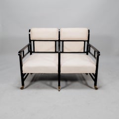 E W Godwin (attributed). An Anglo-Japanese ebonized duet or conversation settee.