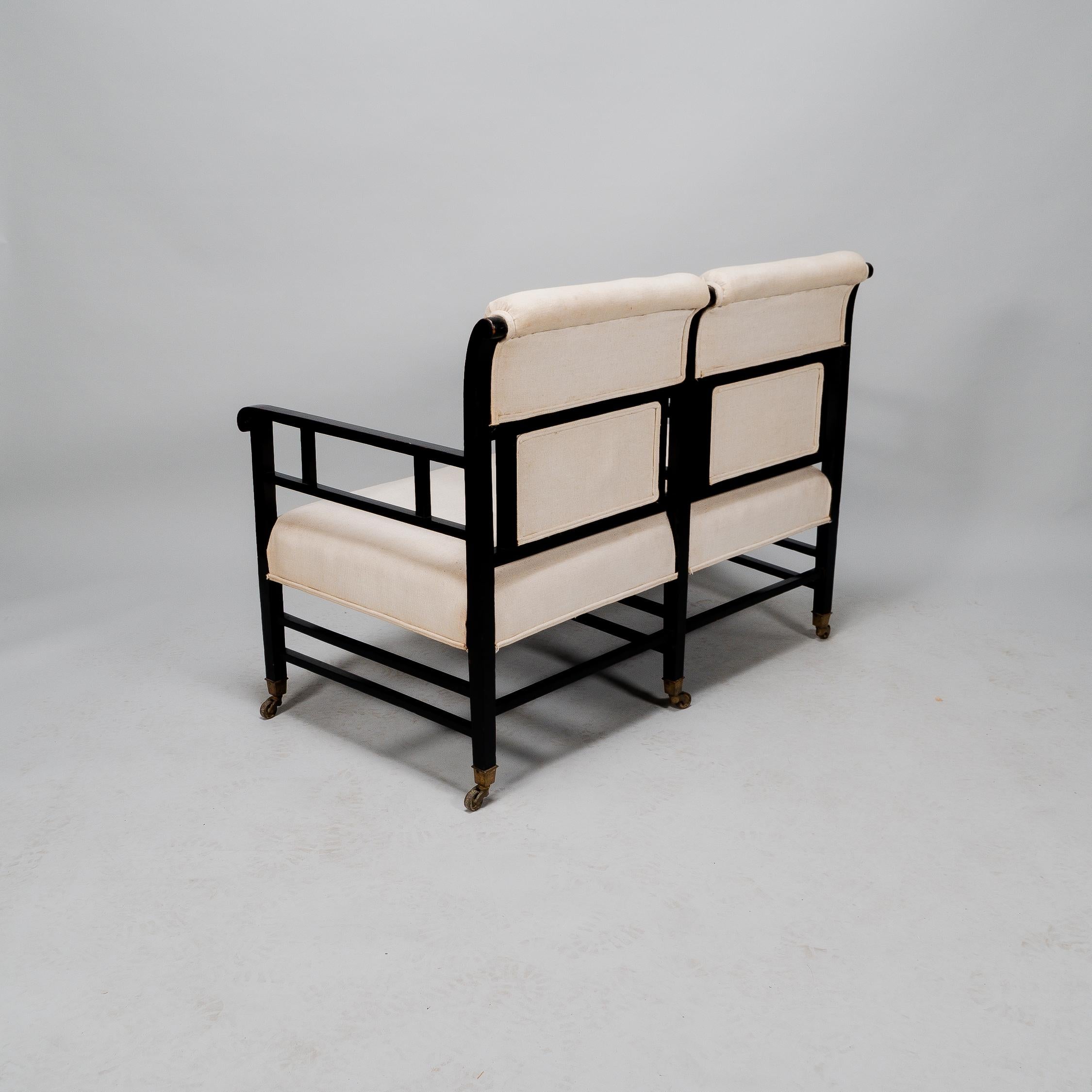 E W Godwin (attributed). An Anglo-Japanese ebonized duet or conversation settee. In Good Condition For Sale In London, GB