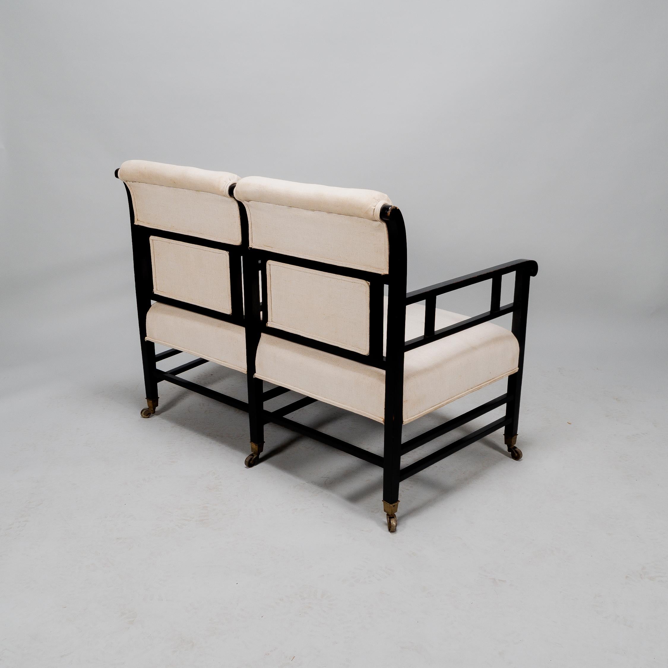 Walnut E W Godwin (attributed). An Anglo-Japanese ebonized duet or conversation settee. For Sale