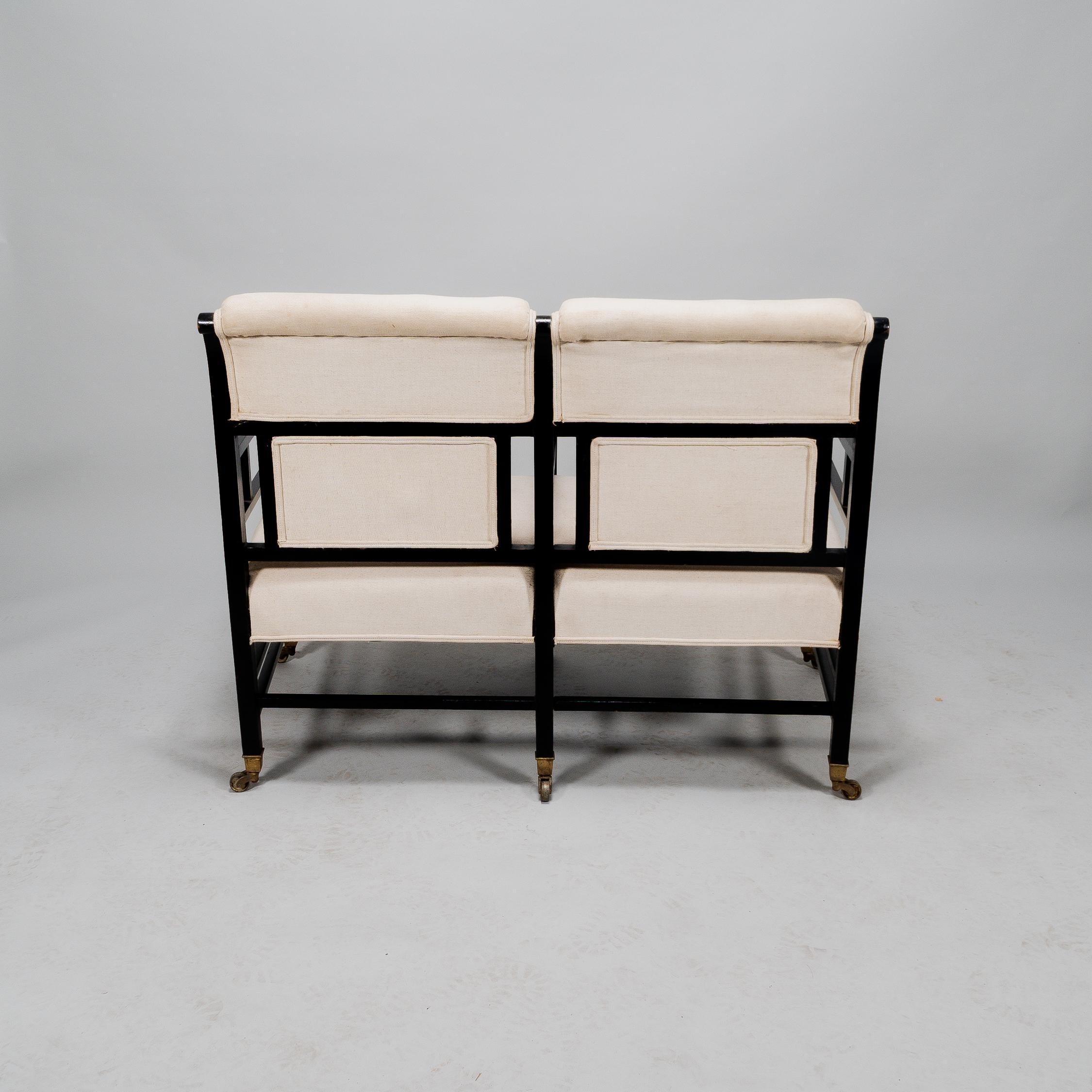 Late 19th Century E W Godwin (attributed). An Anglo-Japanese ebonized duet or conversation settee. For Sale