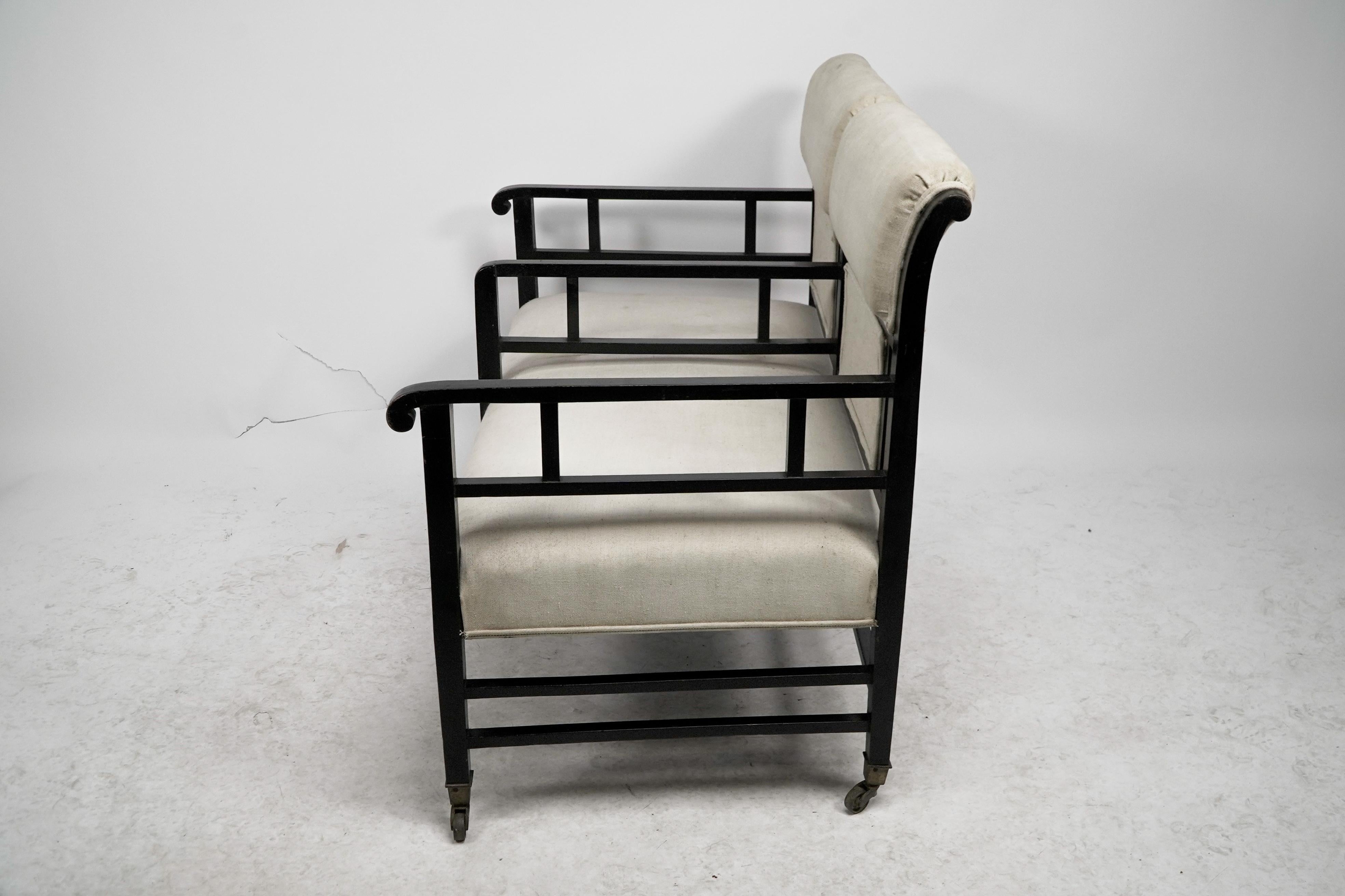 E W Godwin (attributed). An Anglo-Japanese ebonized duet or conversation settee. In Good Condition For Sale In London, GB