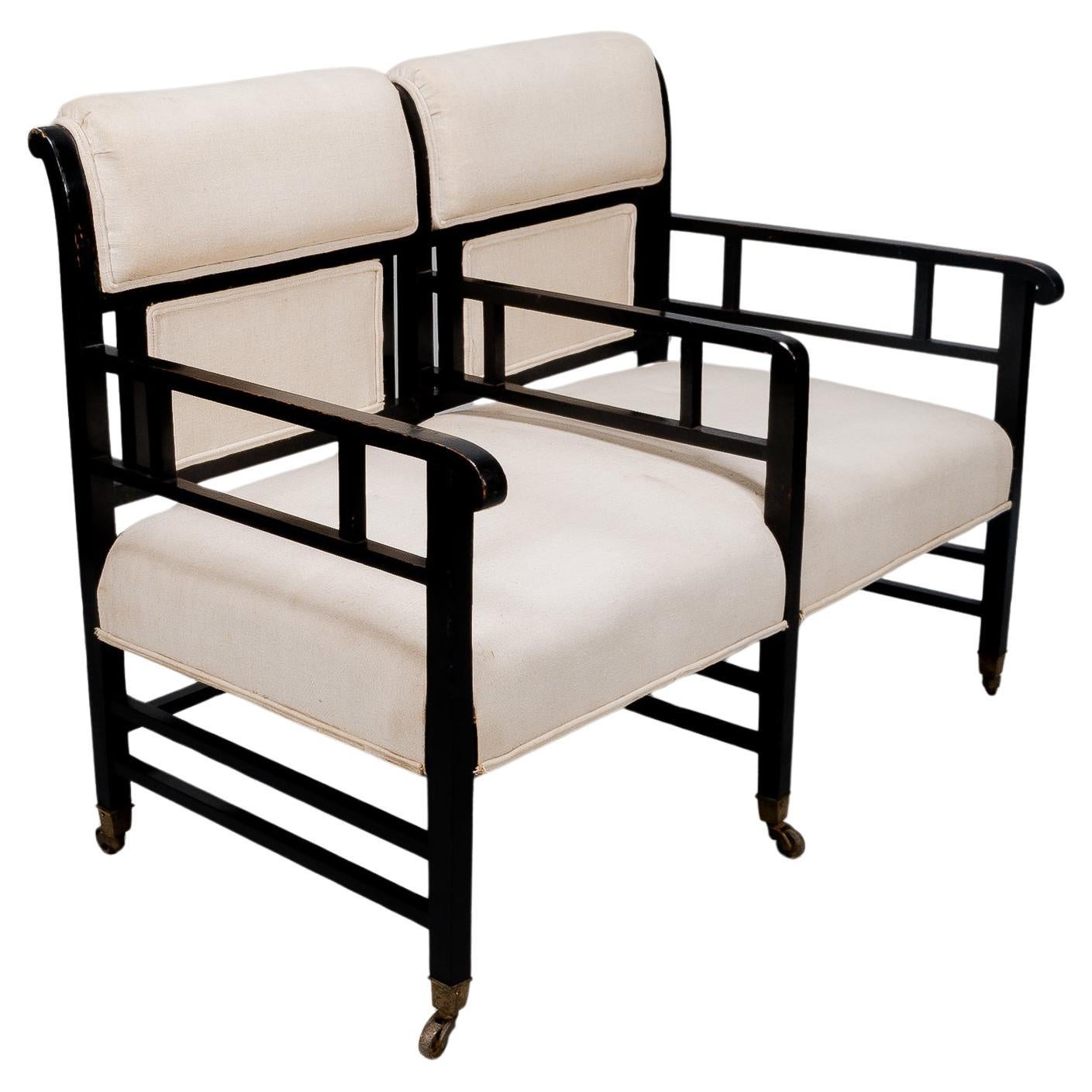 E W Godwin (attributed). An Anglo-Japanese ebonized duet or conversation settee.