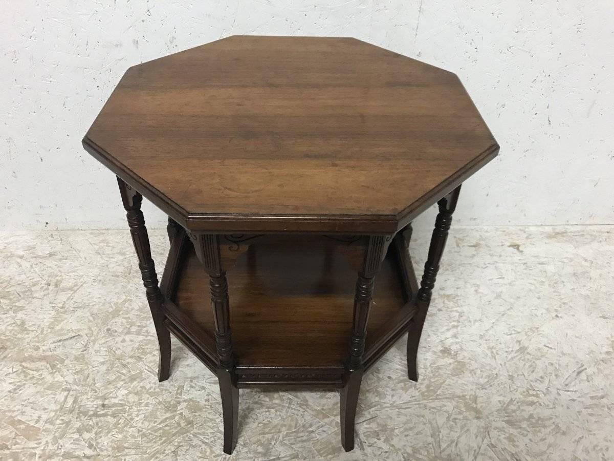 E W Godwin, attributed Collinson and Lock.
A fine Anglo Japanese rosewood octagonal eight leg side table with carved scroll work below the top and Japanese fretwork gallery around the lower shelf, stood on turned and square splayed legs.
Later paper