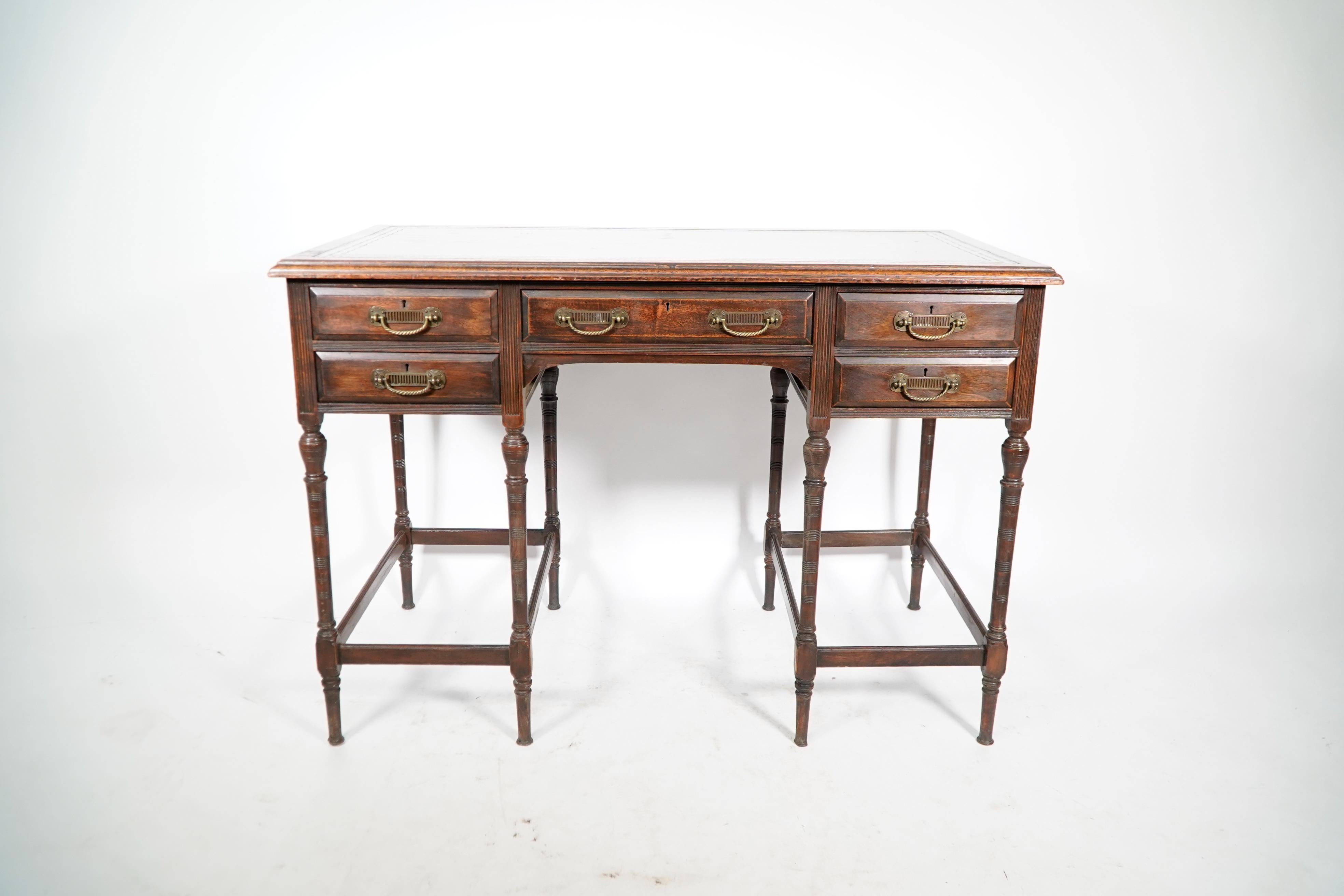 Collinson and Lock. Attributed to E W Godwin. An exceptional quality walnut writing table with five upper drawers each with swan neck handles standing on eight finely turned legs, each side united by circular pierced details.
Renewed period style