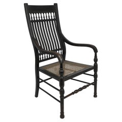 E W Godwin para William Watt Un sillón ebonizado de respaldo alto del Aesthetic Movement.