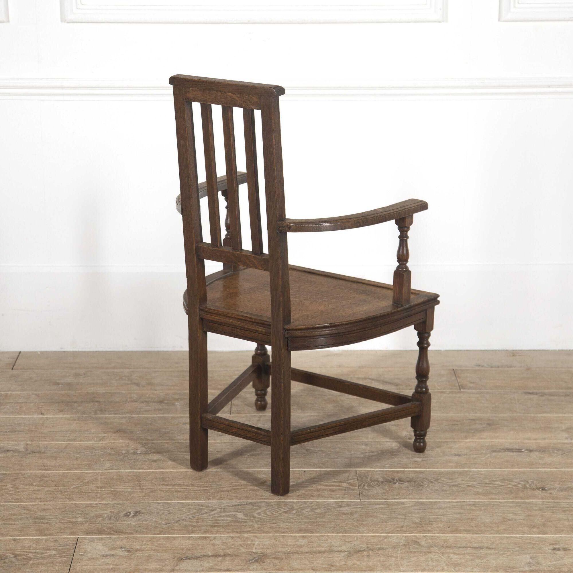 Oak Shakespeare chair, designed by E.W. Godwin and manufactured by William Watt. Circa 1882. 
With wonderful curved armrests and a generous dished seat. The narrow rectilinear back with vertical splats.
This chair is supported on turned legs and