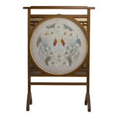E W Godwin style. An Anglo-Japanese fire screen with a Japanese silk embroidery.