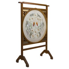 E W Godwin style. An Anglo-Japanese fire screen with a Japanese silk embroidery.