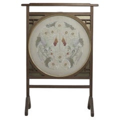 E W Godwin style. An Anglo-Japanese fire screen with a Japanese silk embroidery.