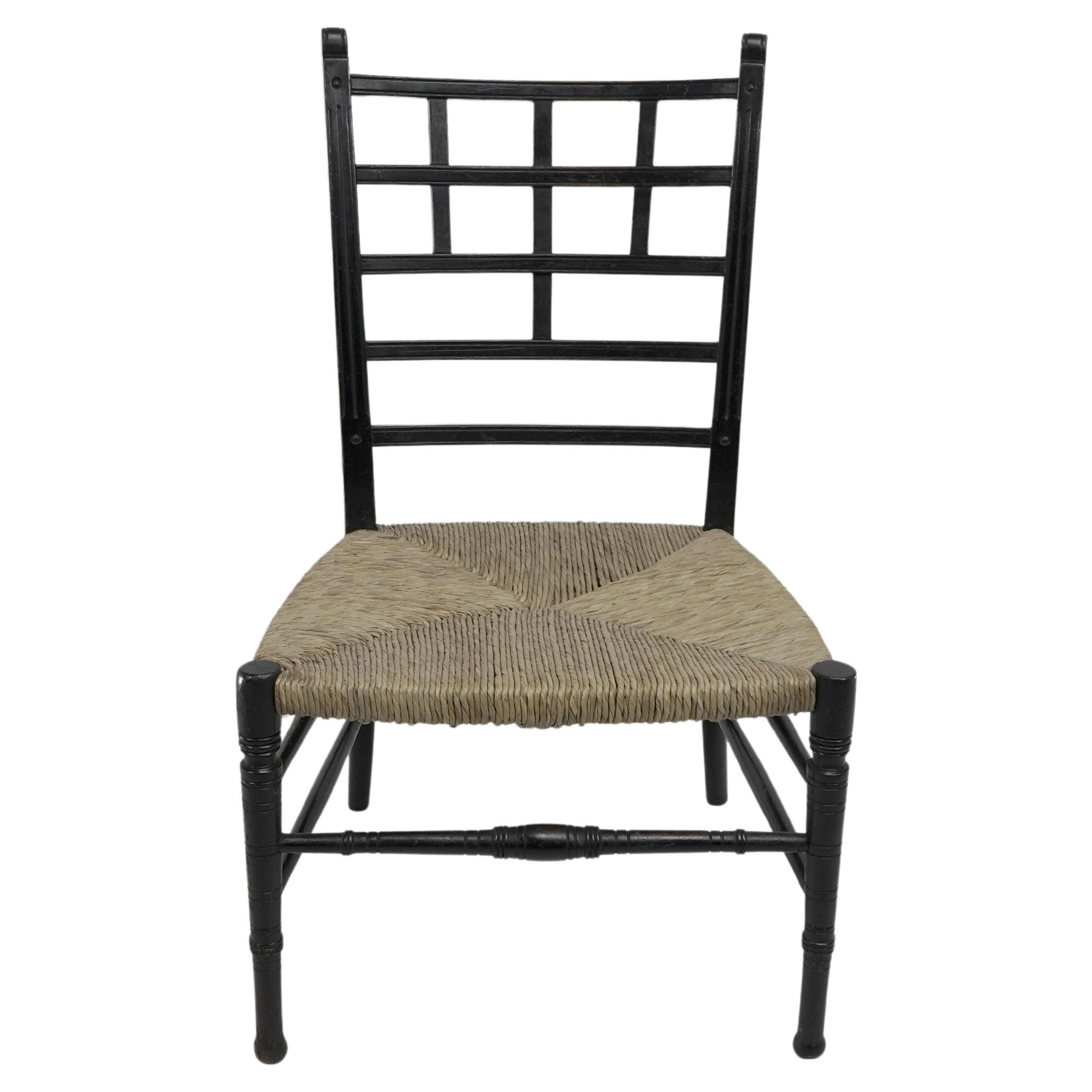 E.W. Godwin style of. An Anglo-Japanese ebonized side chair with new laid rush.
