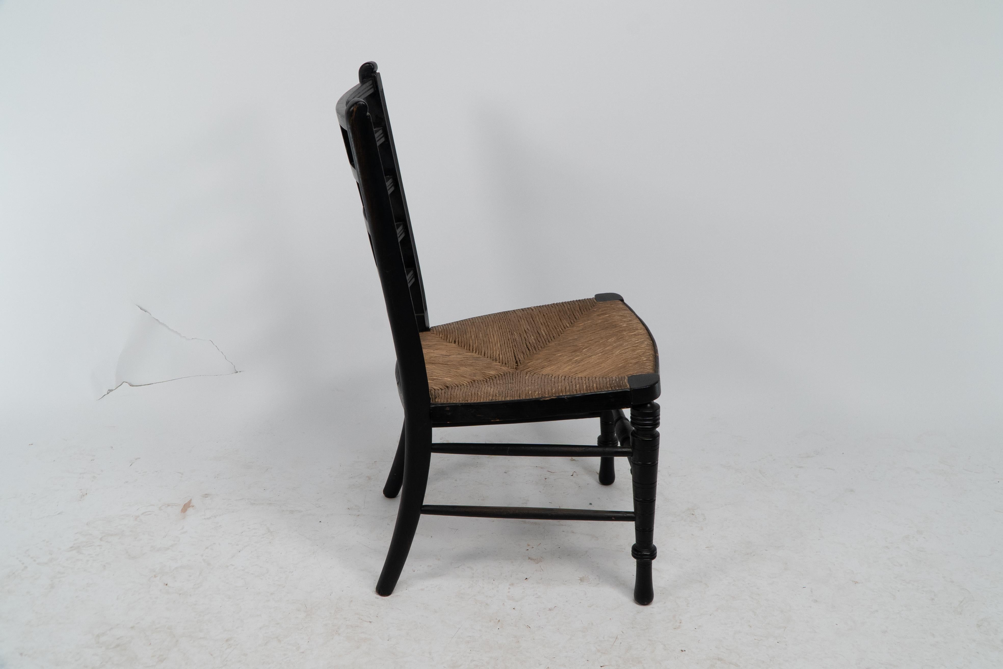 E W Godwin (style of). An Anglo-Japanese rush seat ebonized side chair In Good Condition For Sale In London, GB