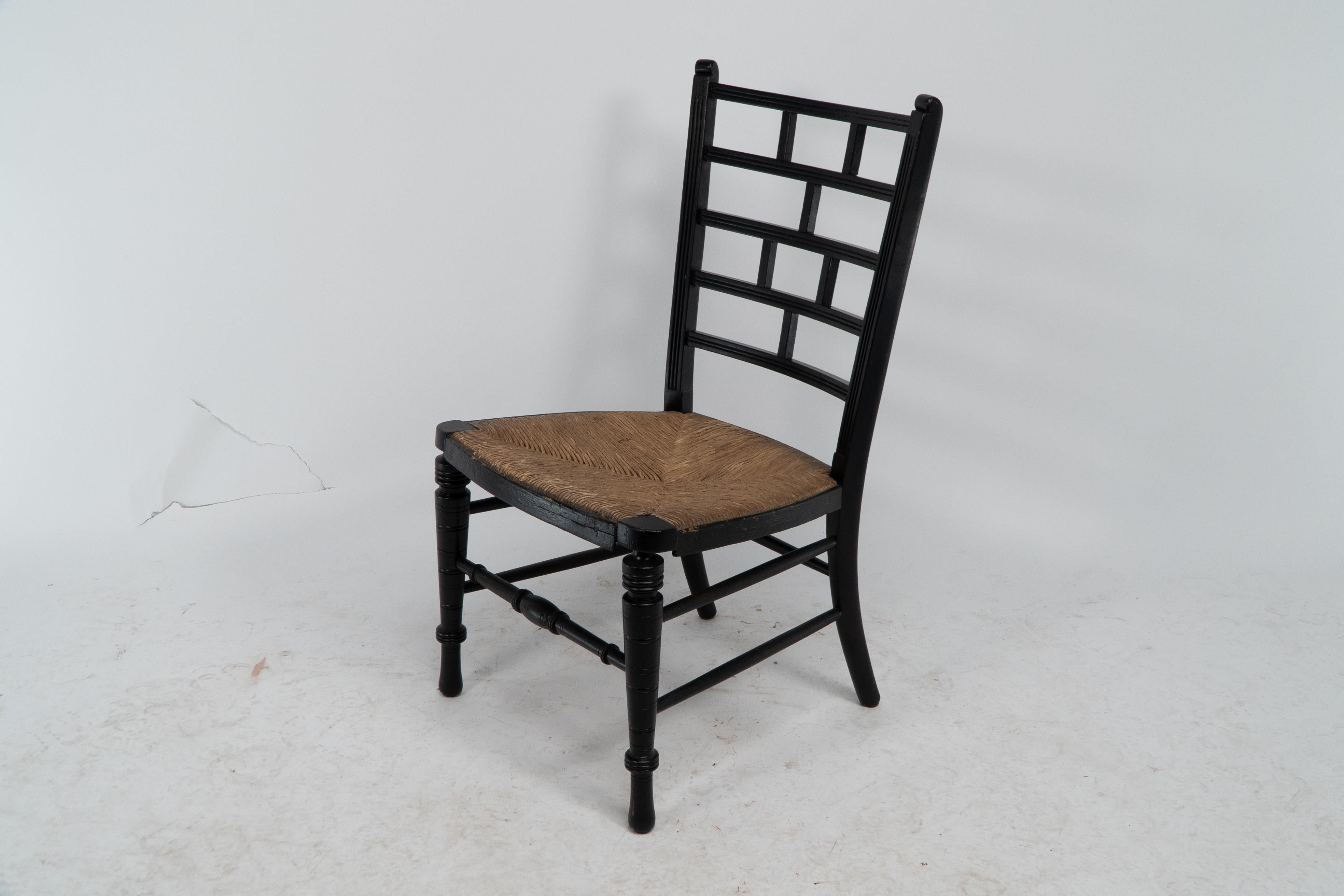 English E W Godwin (style of). An Anglo-Japanese rush seat ebonized side chair For Sale