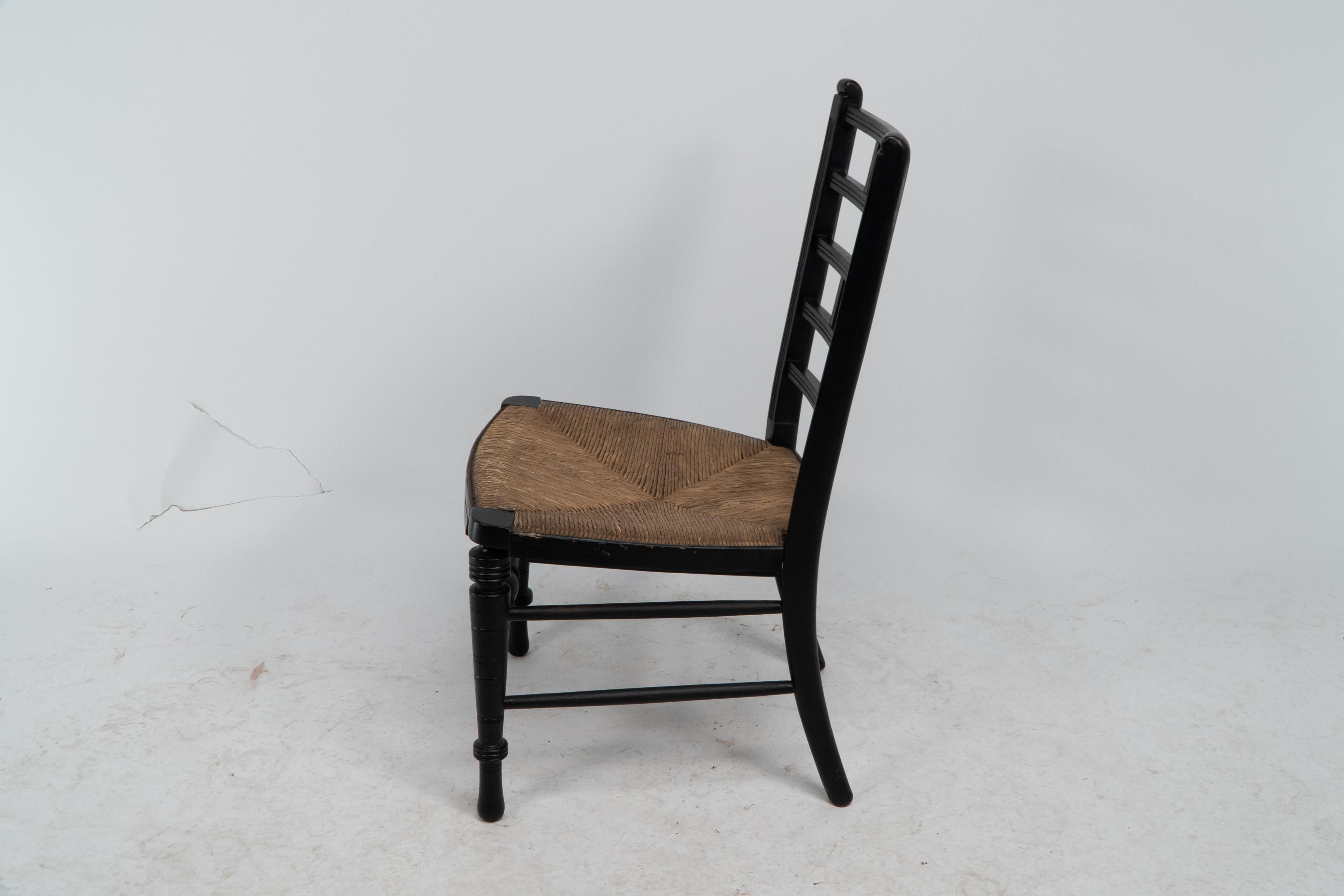 Ebonized E W Godwin (style of). An Anglo-Japanese rush seat ebonized side chair For Sale