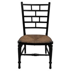 E W Godwin (style of). An Anglo-Japanese rush seat ebonized side chair