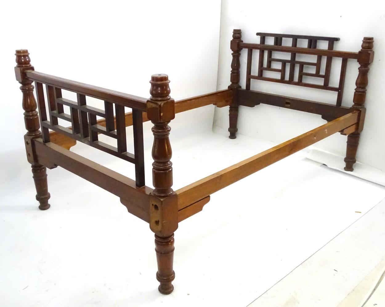 An extremely rare Anglo-Japanese walnut double bed or a four poster bed, in the style of E W Godwin probably made by Collinson and Lock of London.
With higher Lattice work bar to the head board which has curled ends and central lattice work details