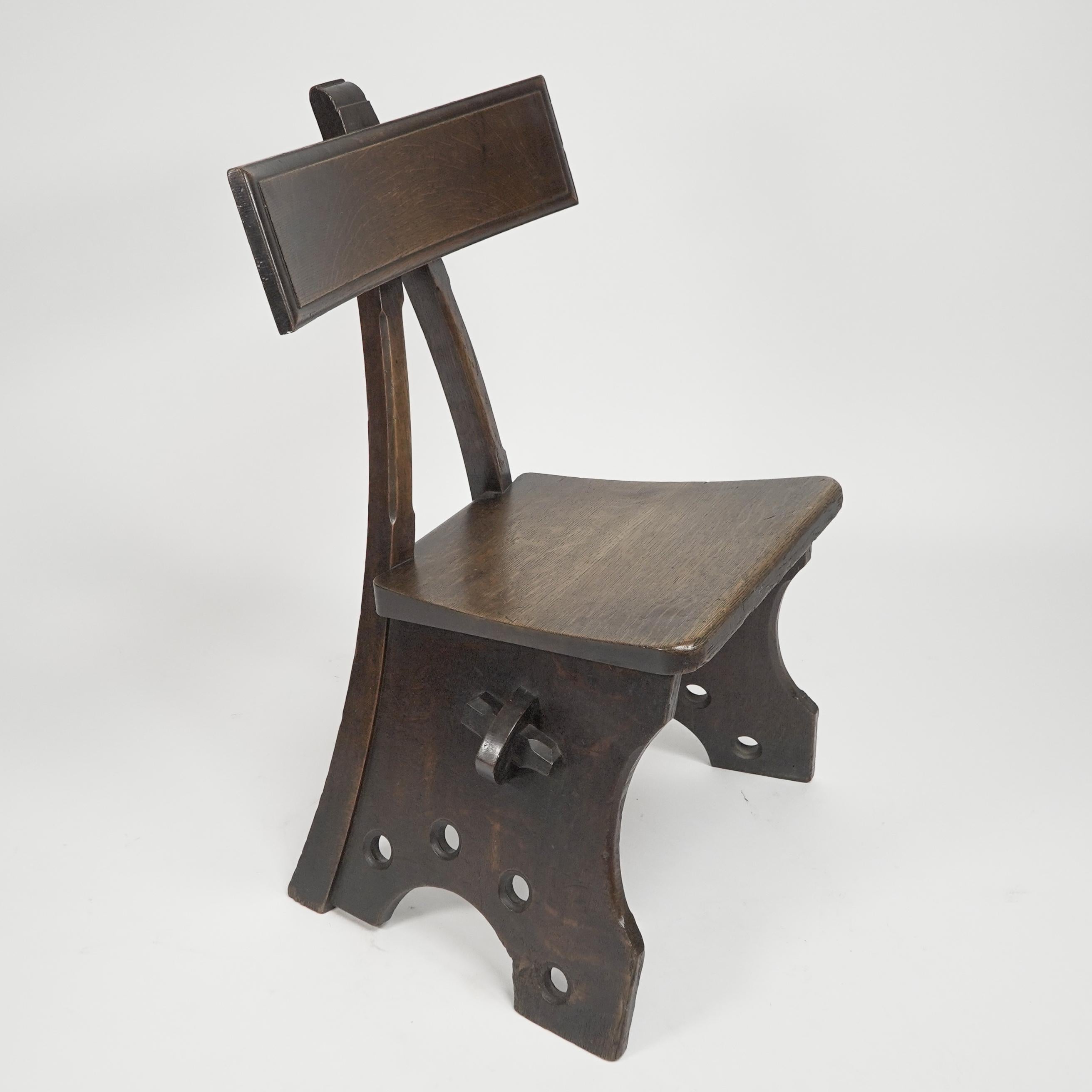 E. Welby Pugin. A Gothic Revival oak chair design can be found in the Public Record Office, Kew. (BT/43/58, no. 245877)., and is titled 'front elevation of chair quarter real size'. The chair was part of the interiors E. W. Pugin designed for the
