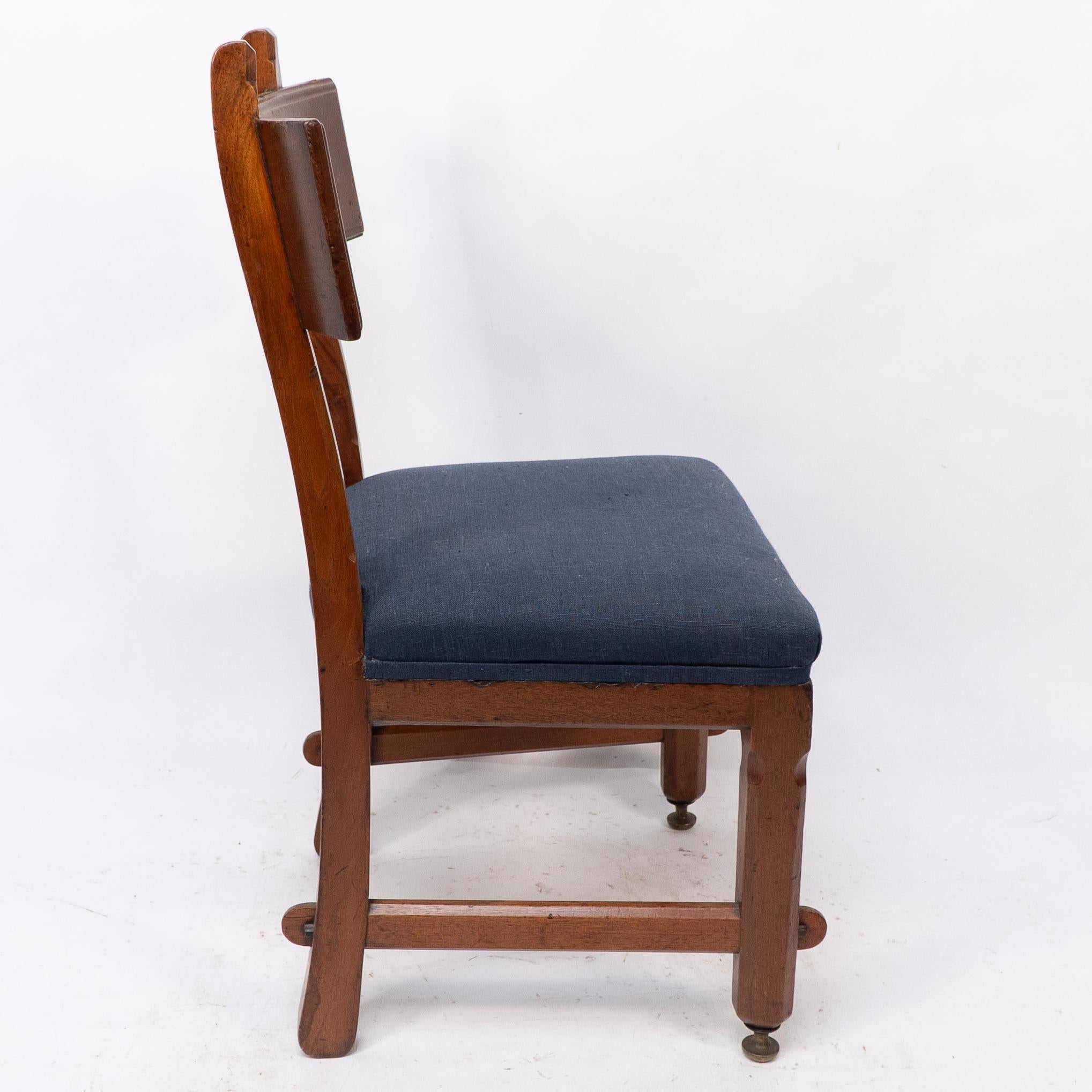 Arts and Crafts E W Pugin. A walnut side chair with curvaceous back rest with oak pegs For Sale