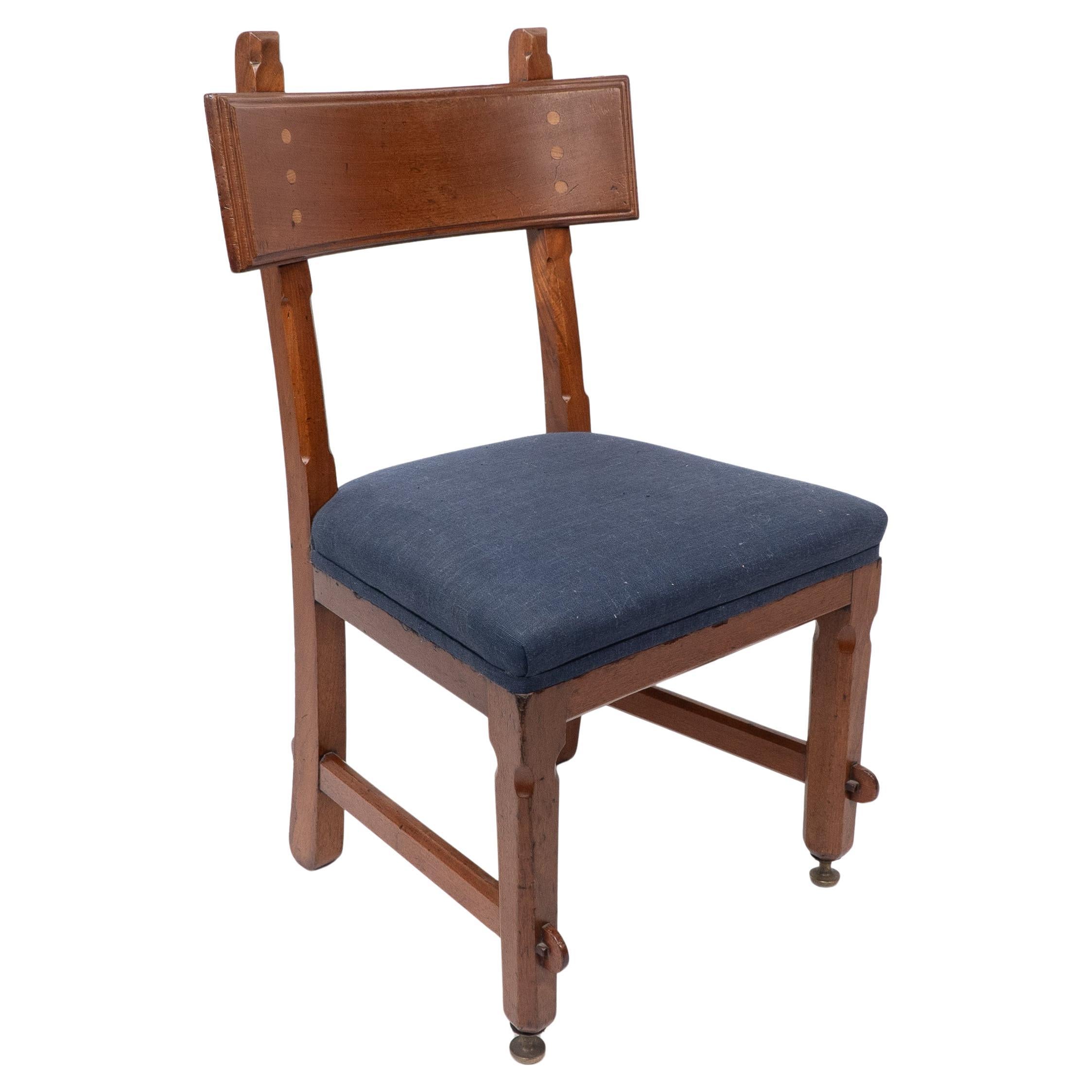 E W Pugin. A walnut side chair with curvaceous back rest with oak pegs For Sale