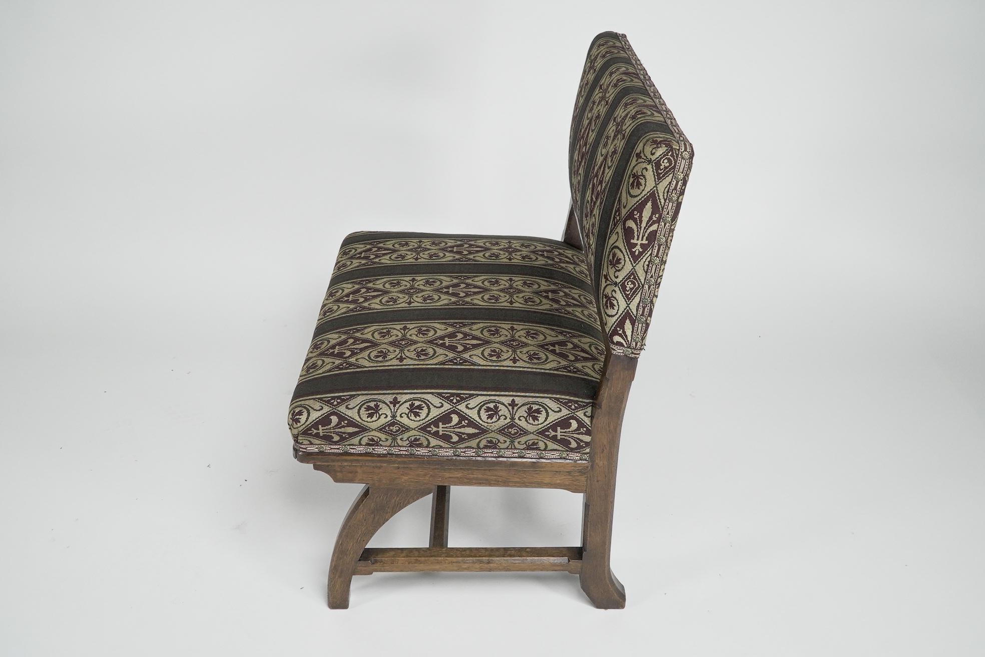Late 19th Century E W Pugin attri. A Gothic Revival oak duet chair with a wider than usual seat. For Sale