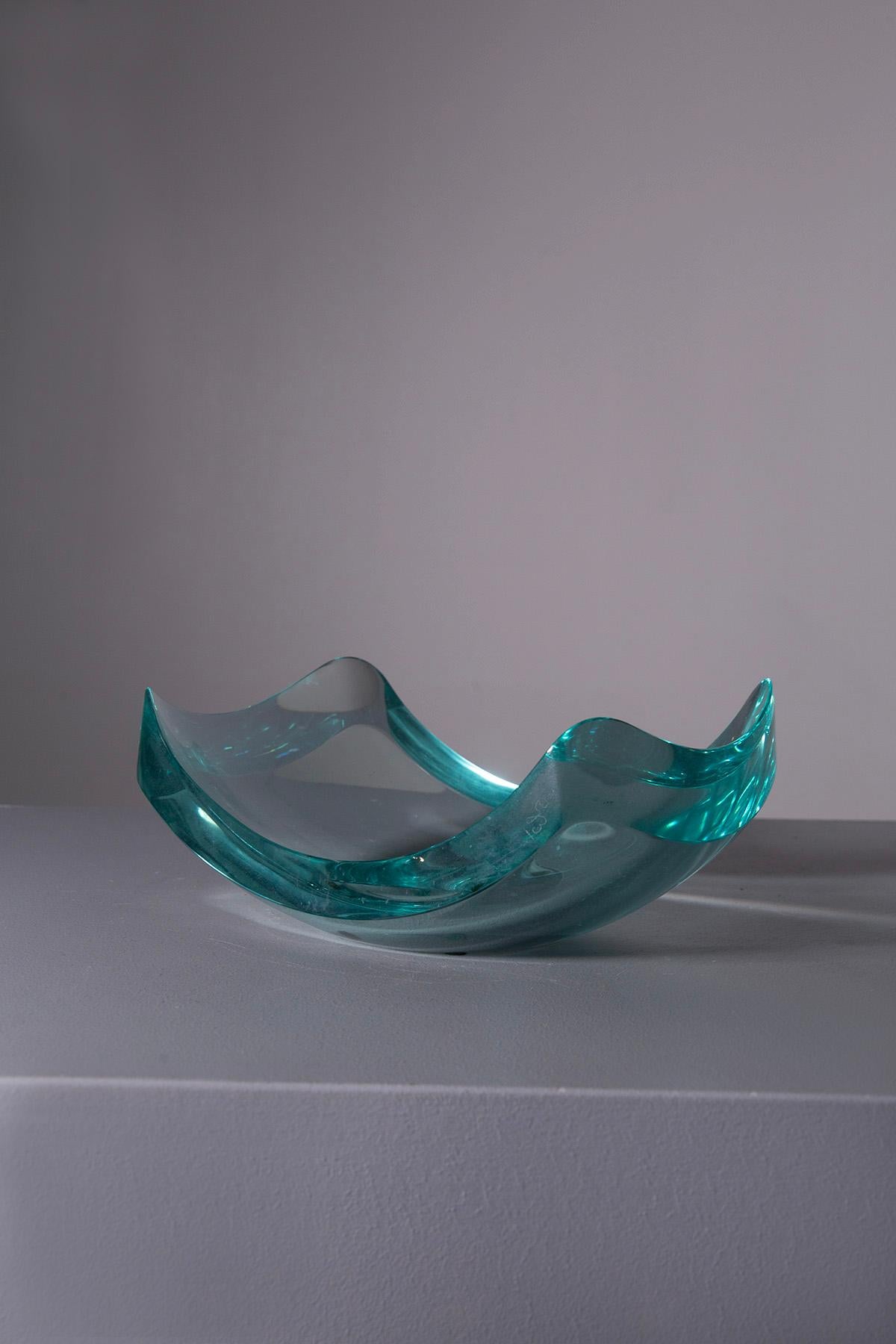 A masterpiece of grace and craftsmanship, this elegant 1950s beveled crystal bowl emptier bears the unmistakable signature of Erwin Walter Burger for Fontana Arte. Entirely hand ground, the crystal is transformed into a pure work of art with its