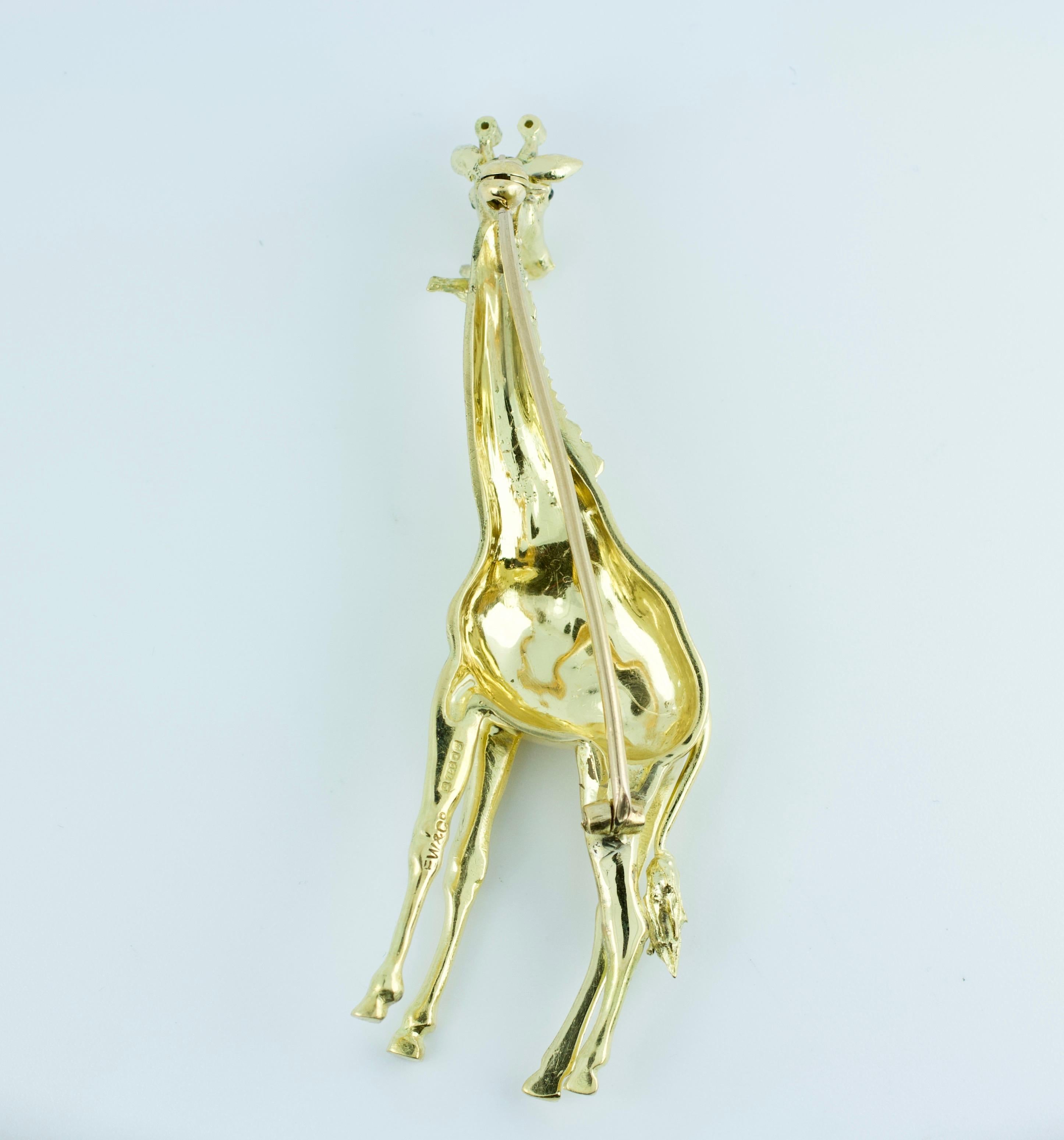 E. Wofle & Co. 18k Yellow Gold Round Diamond Giraffe Pin
20.2 Grams
2.75 Inches tall
1 inch wide
2 Round White Diamonds 
2 Round Beryl Eyes
This is a very unique Pin. It was made by E. Wolfe & Co. and this highly detailed pin also has hallmarks that