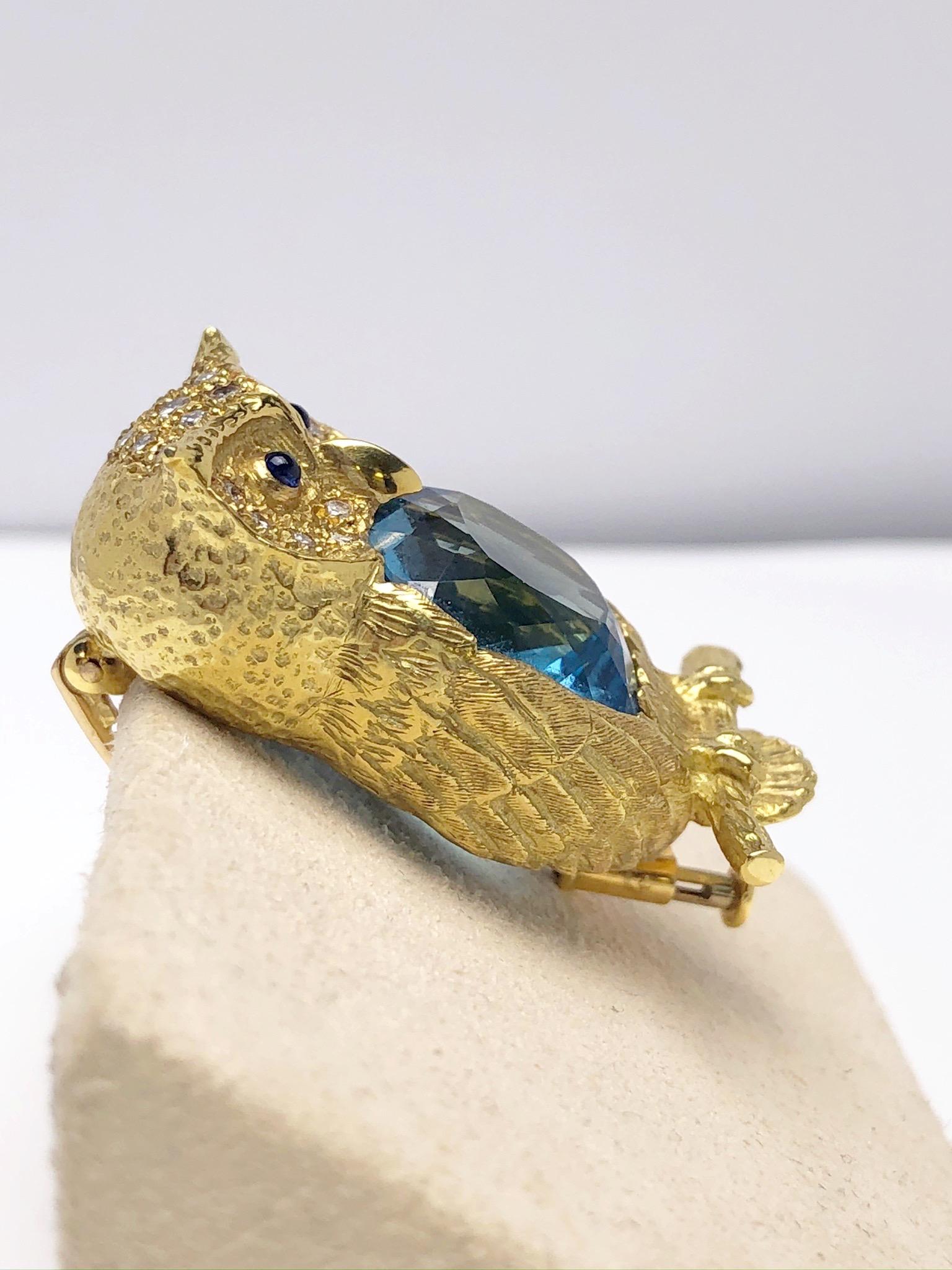 This Lovely 18 karat yellow gold owl brooch features a 17.86 carat blue topaz center, Cabochon Sapphire eyes and a sprinkle of Diamonds around the owls eyes. 

E. Wolfe & Co is a family-run fine jewellery manufacturing Workshop, established in 1850