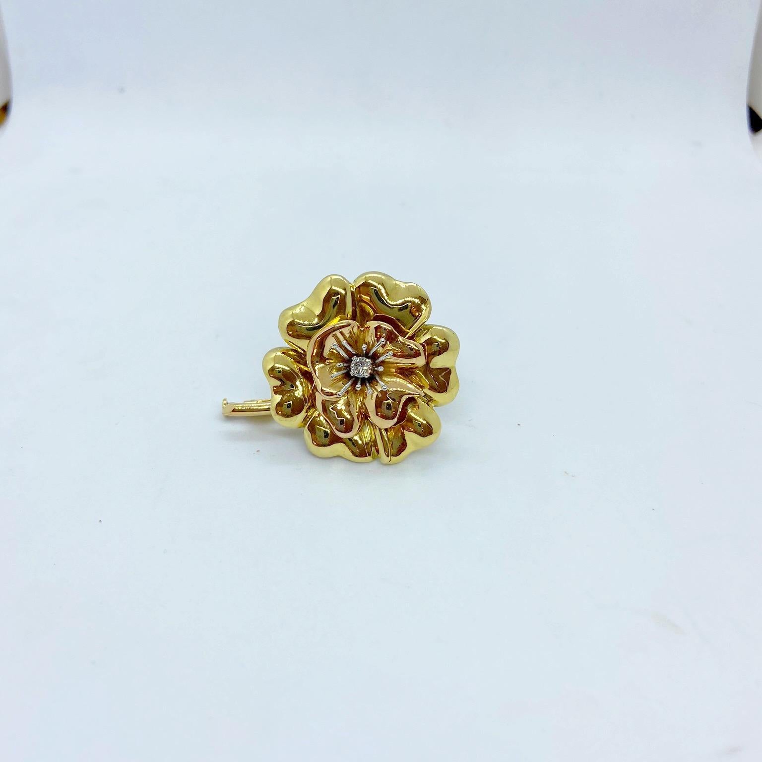 E. Wolfe & Co is a family-run fine jewellery manufacturing Workshop, established in 1850 and located in central London. They specialize in creating beautiful bespoke pieces - such as this one created for Cellini Jewelers In NYC. 
A beautiful flower