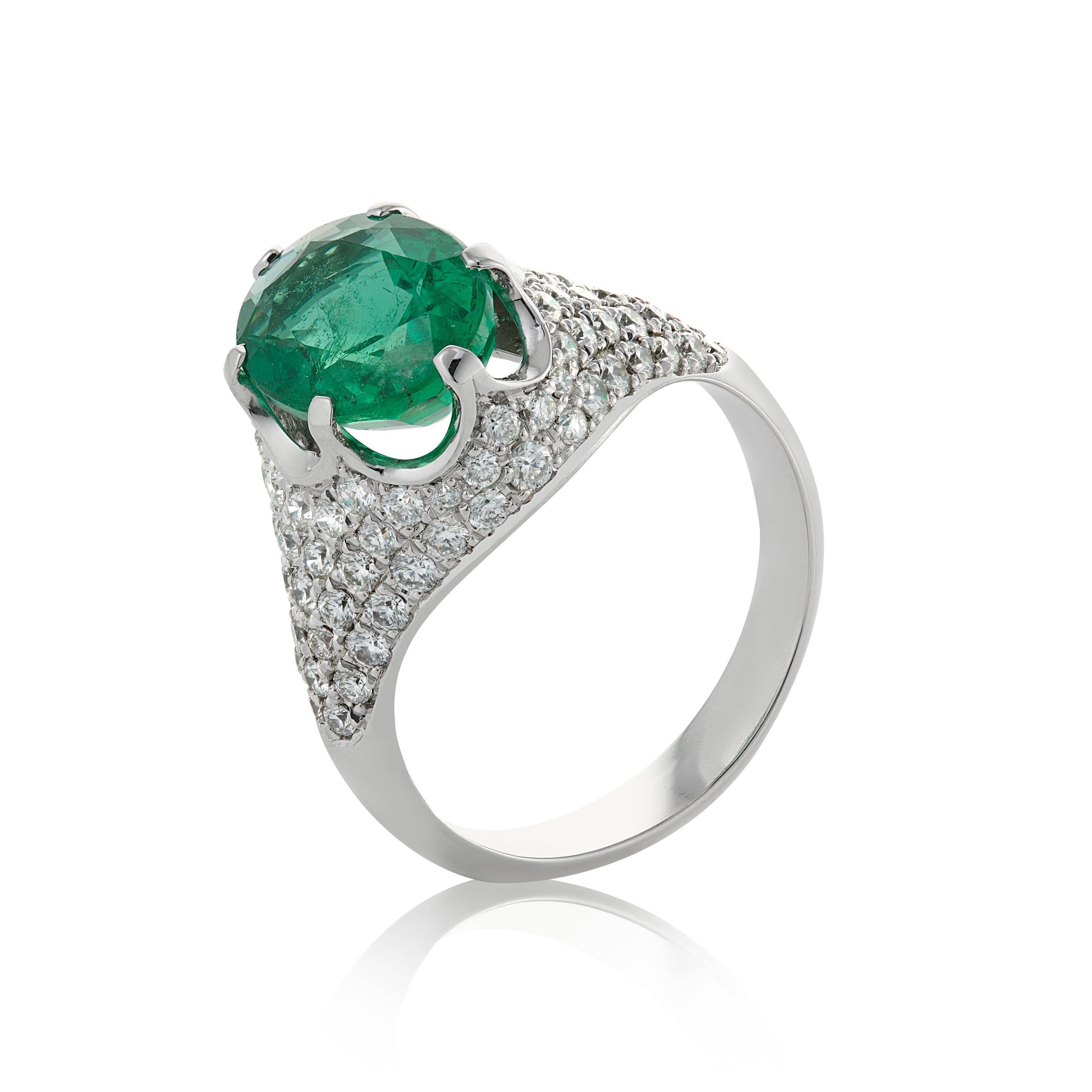 E Wolfe & Co Handmade 18ct White Gold Emerald and Diamond Cocktail Ring. The oval-cut emerald centre stone weighs 2.95 carats, is a pleasing stone and is surrounded by .92 carats of G colour and VS clarity round brilliant-cut diamonds set in pave
