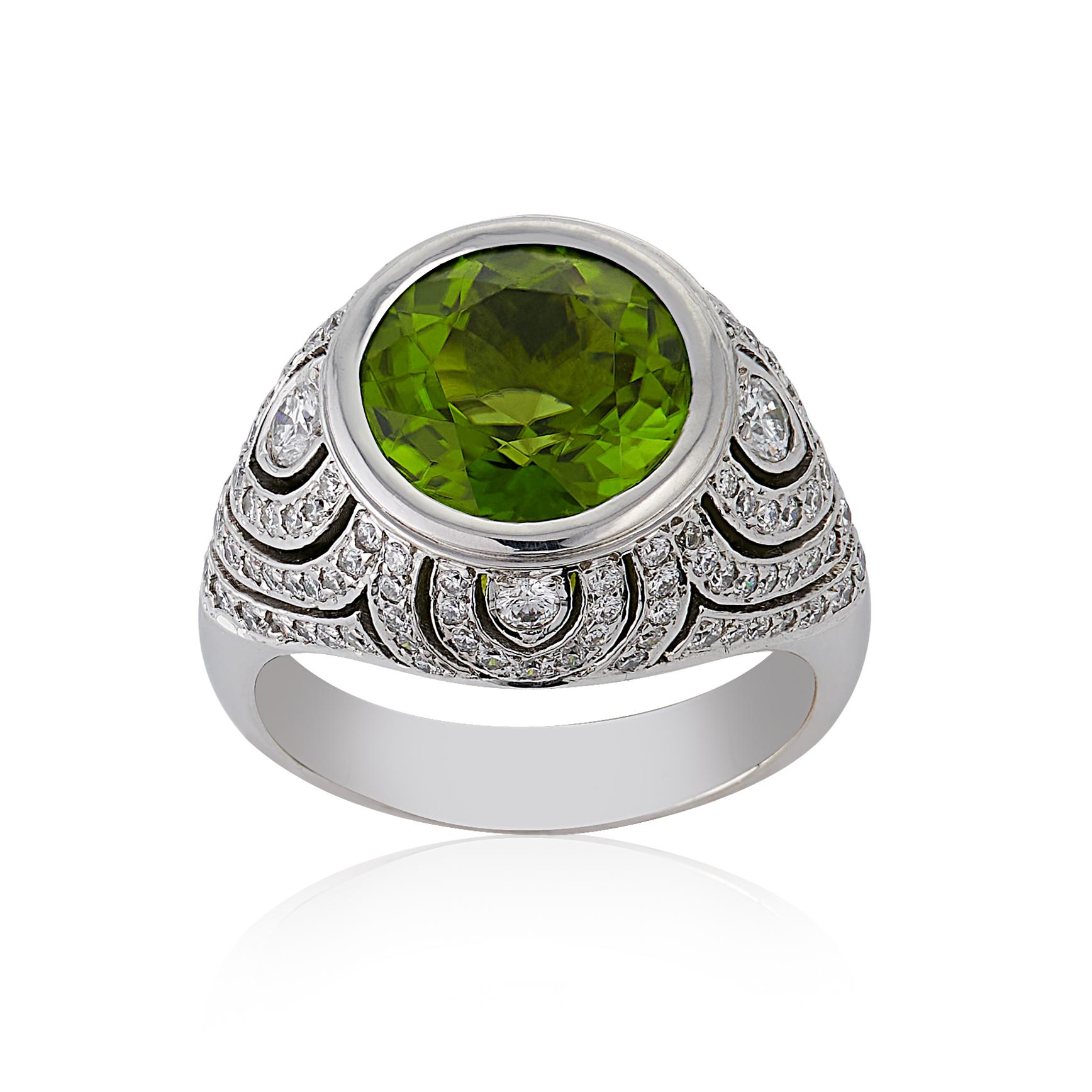 E Wolfe & Co Handmade 18ct White Gold Peridot and Diamond Cocktail Ring. The peridot centre stone weighs 6.26 carats, is of extremely good colour and is surrounded by intricate detail which has been set with 1.74 carats of G colour and VS clarity