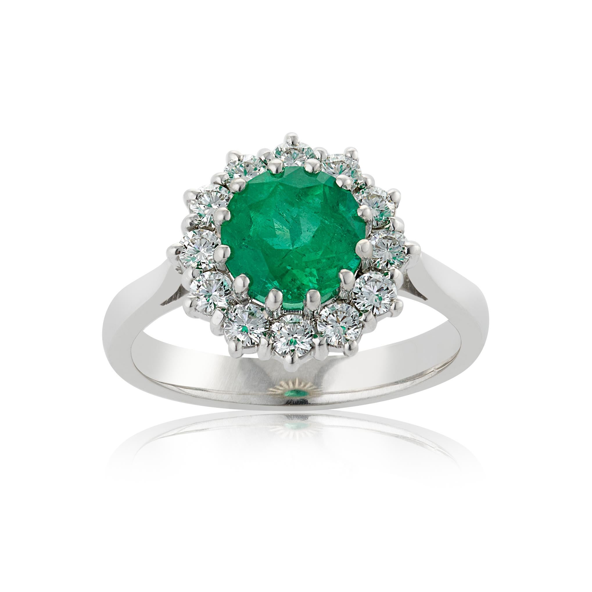 E Wolfe & Company Handmade 1.58 carat Emerald and Diamond 18ct white gold Cluster Ring. The round cut emerald centre stone weighs 1.58 carats and is surrounded by 12 round brilliant diamonds which collectively weigh .59 carats. The diamonds are of G