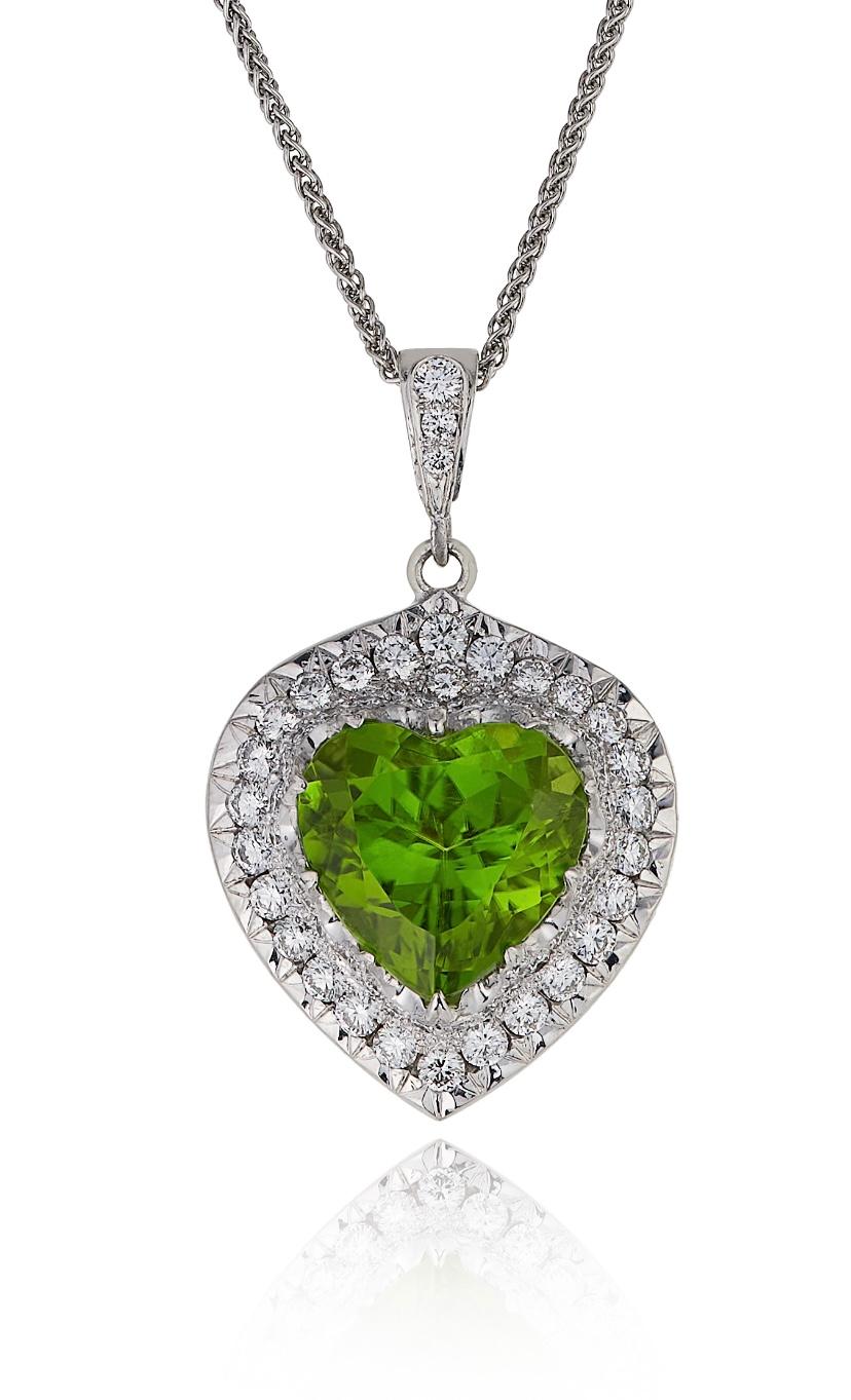 E Wolfe & Company 18 Carat White gold Peridot and Diamond Pendant. The heart-shaped Peridot weighs 5.53 carats and is set with surrounding round brilliant cut diamonds which have a total weight of 1.20 carats and are of G colour and VS clarity. The
