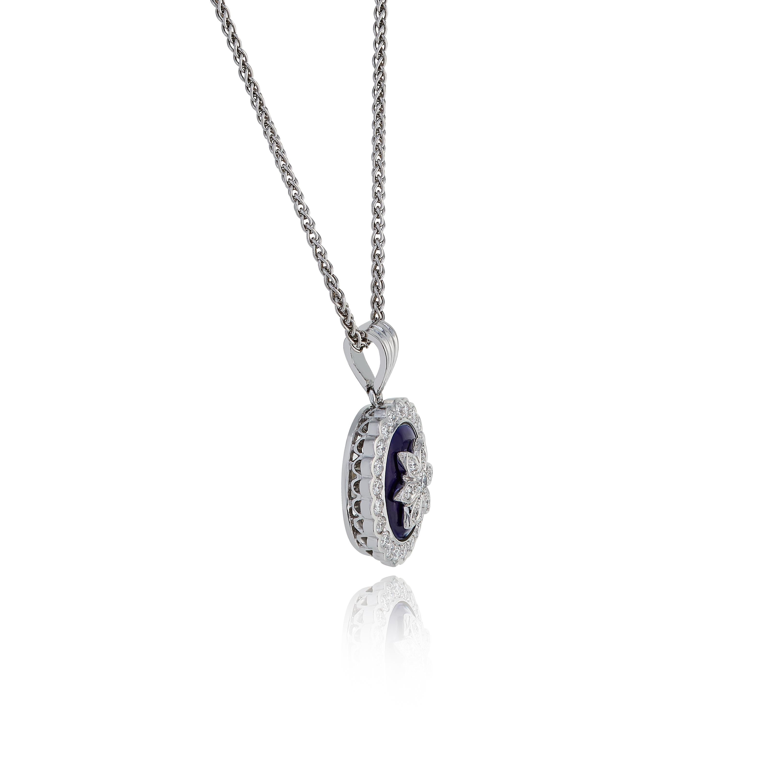 E Wolfe & Company 18 Carat White Gold Enamel and Diamond-set Flower Pendant. The Pendant has been vitreous enamelled in a rich royal blue colour and the flower's petals set with diamonds. The round brilliant cut diamonds set to the petals and to the