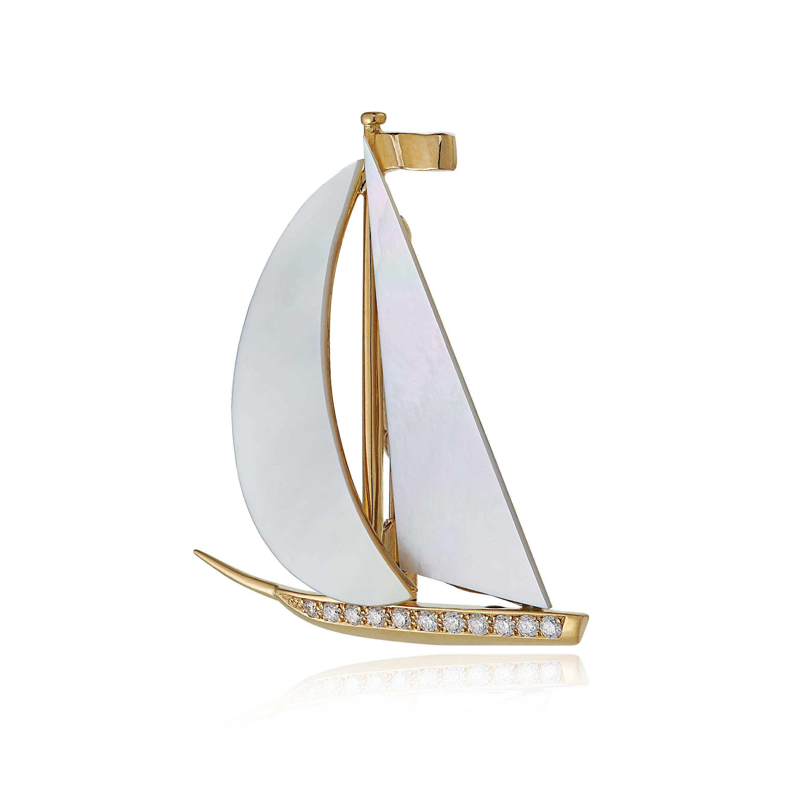 E Wolfe & Company 18 carat Yellow Gold and Mother of Pearl Sailing Boat Brooch. The boat's sails consist of mother of pearl sections and there are .15 carats diamonds of G colour and VS clarity diamonds set to the lower section. The brooch was
