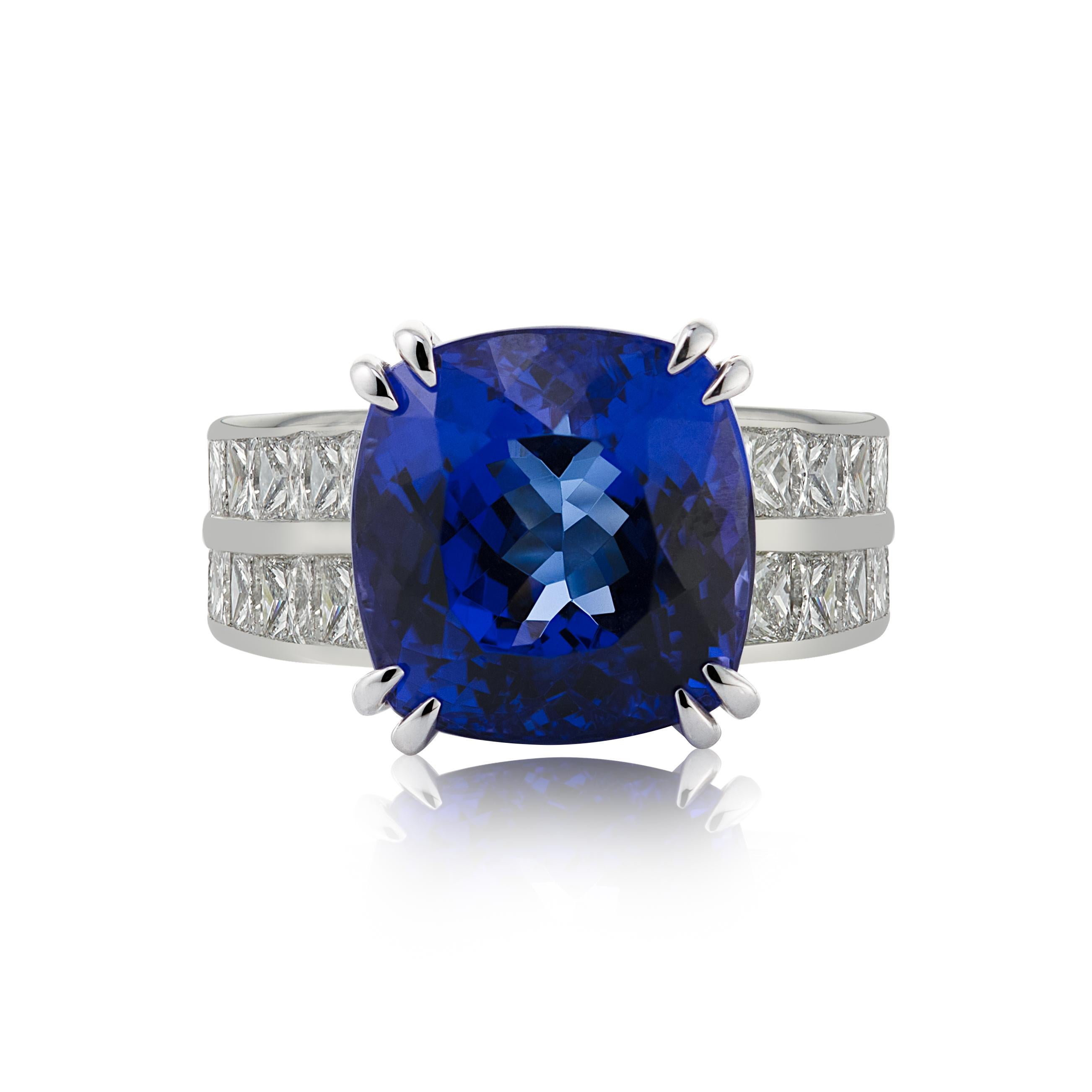 E Wolfe & Company Handmade 18 carat White Gold Tanzanite and Diamond Cocktail Ring. The tanzanite centre stone weighs 9 carats, is of extremely good colour and has two rows of princess-cut diamonds set to either side of the white gold ring band. The