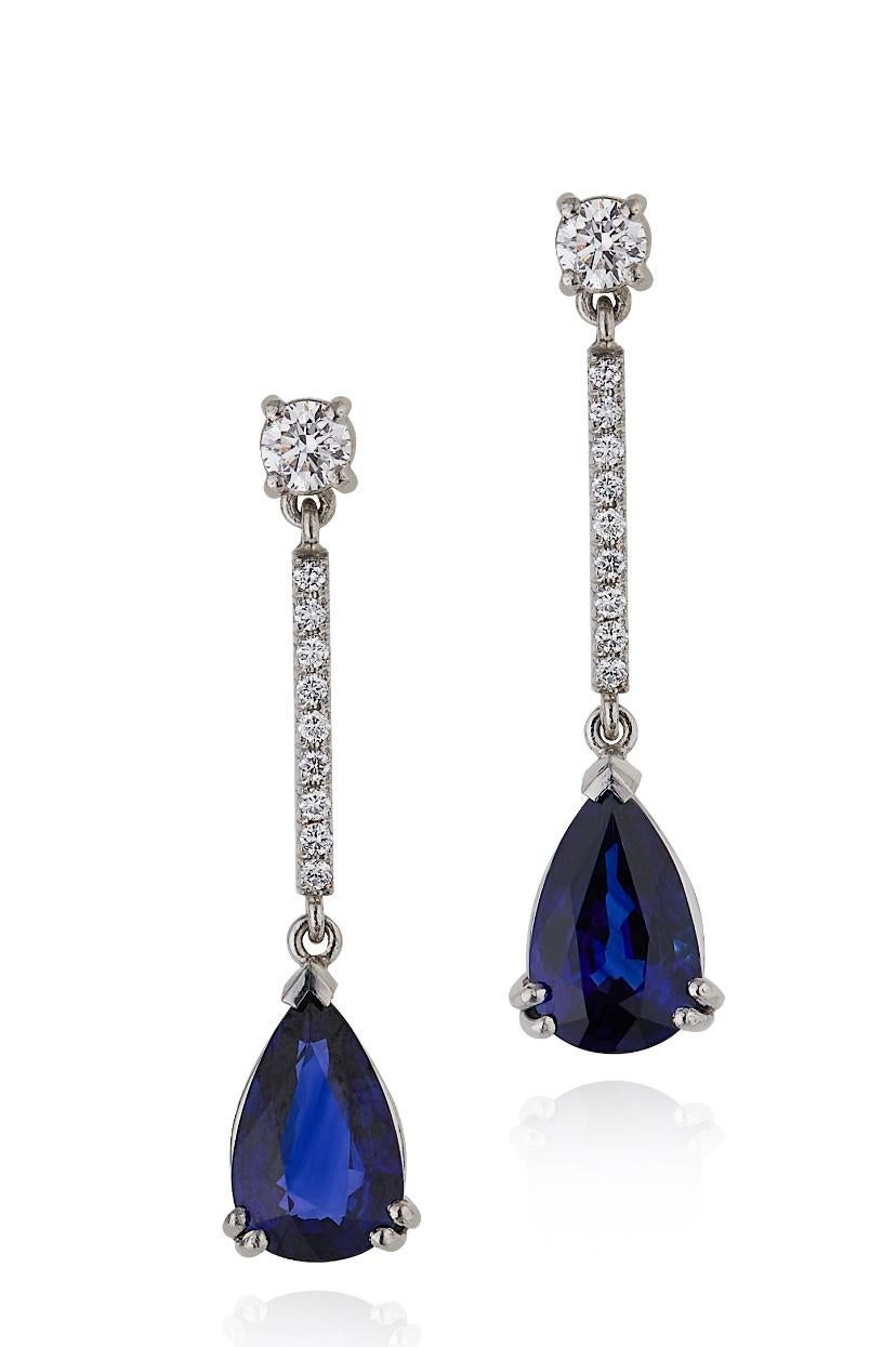 E Wolfe & Company Handmade Platinum Sapphire and Diamond Drop Earrings. The two pearshape sapphires weigh 2.80 carats and are of a highly sought after royal blue colour. The round brilliant cut diamonds have a total weight of .32 carats and are of G