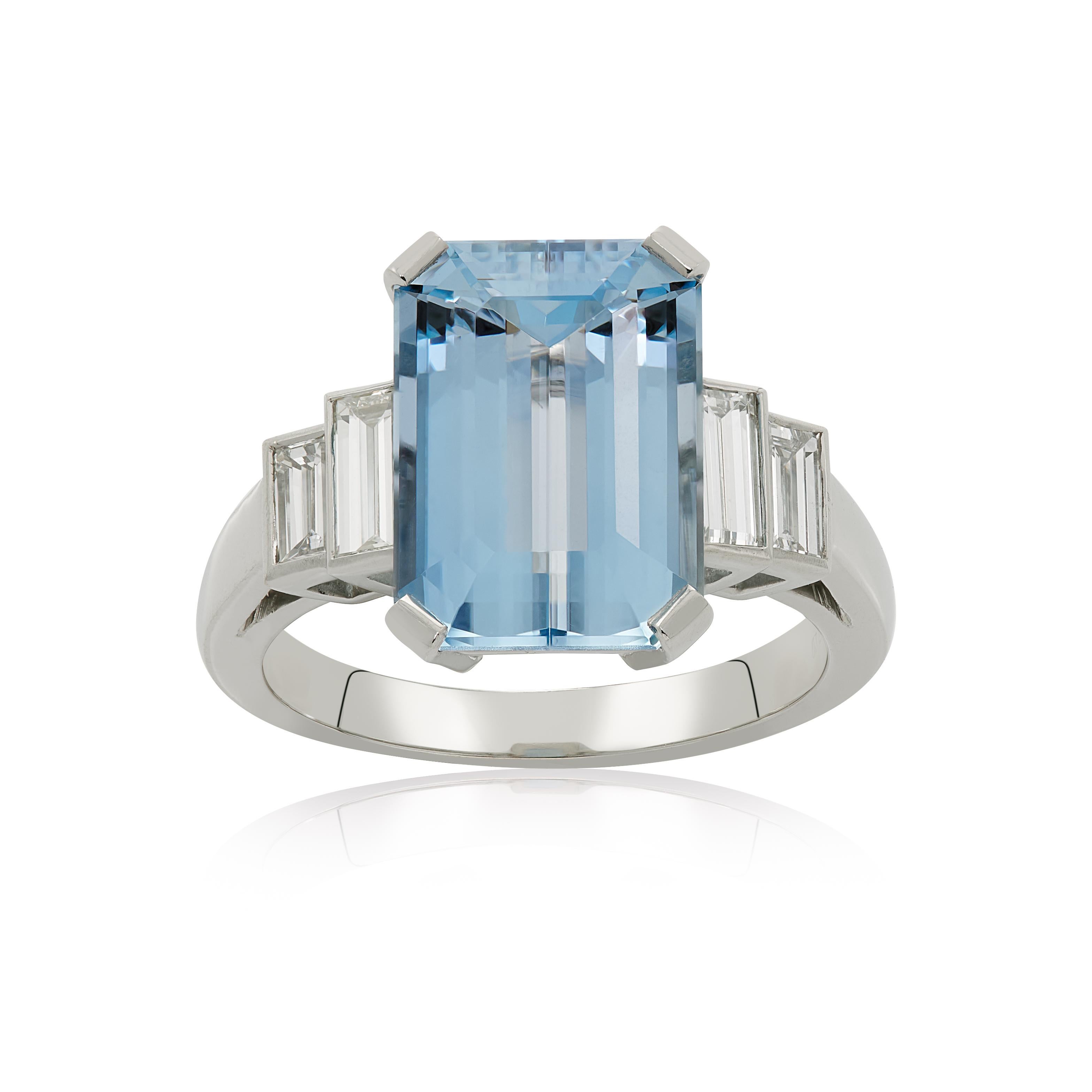 E Wolfe & Co Handmade Platinum Aquamarine and Diamond baguette Ring. The emerald-cut aquamarine centre stone weighs 4.33 carats and has two pairs of baguette diamonds set to either side of the platinum ring band. The baguette diamonds have a total