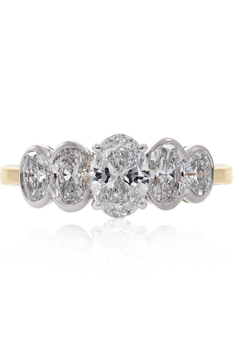 E Wolfe & Company Handmade 18ct Yellow Gold Five Stone Diamond Ring. The five oval-cut diamonds are set in 18ct white gold settings to the 18ct yellow gold ring shank. The central oval diamond weighs .76cts and the four other oval-cut diamonds weigh