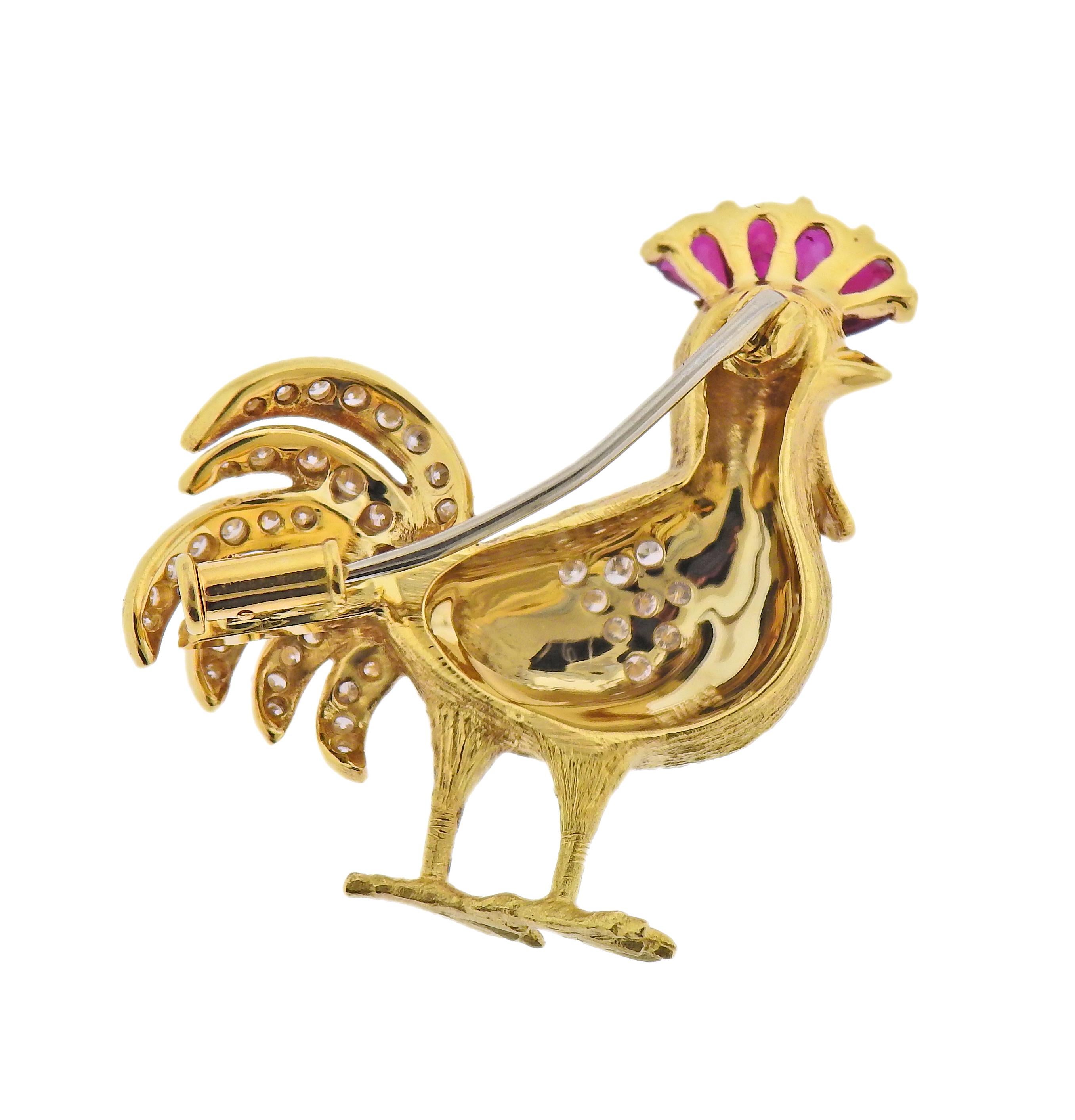E. Wolfe rooster brooch in 18k gold, adorned with rubies and approx. 0.22ctw in diamonds. Brooch measures 32mm x 30mm. Marked: EW & Co., 750. Weight - 10.3 grams. 