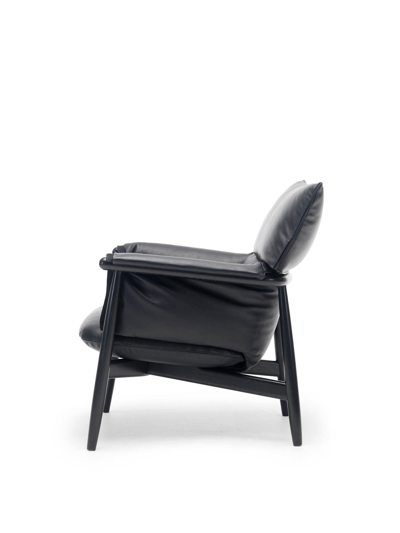EOOS designed the E015 Embrace lounge chair to provide superior comfort. The chair consists of a continuously visible wooden structure with a three-piece, rounded back and characteristic legs adding to the overall frame. The seating is created with