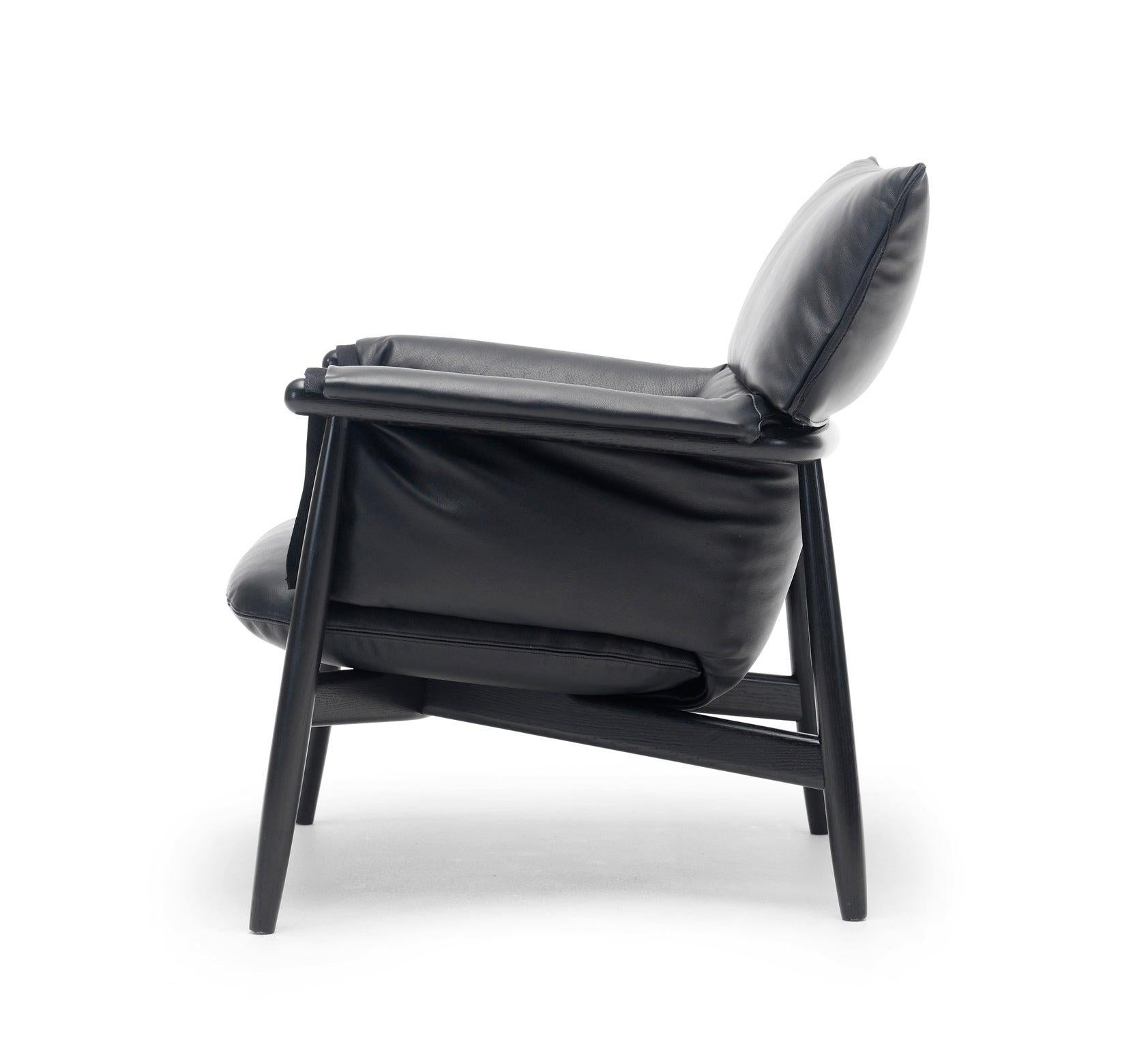 EOOS designed the E015 Embrace lounge chair to provide superior comfort. The chair consists of a continuously visible wooden structure with a three-piece, rounded back and characteristic legs adding to the overall frame. The seating is created with
