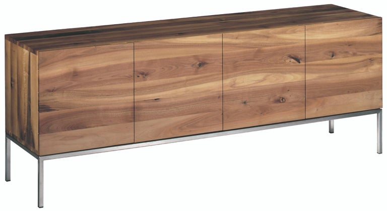 The sideboard FARAH is a refined storage solution. The horizontal display of the solid wood grain makes each sideboard unique and elegantly highlights the combination of solid wood and a seamless stainless steel frame. aluminum strips inserted