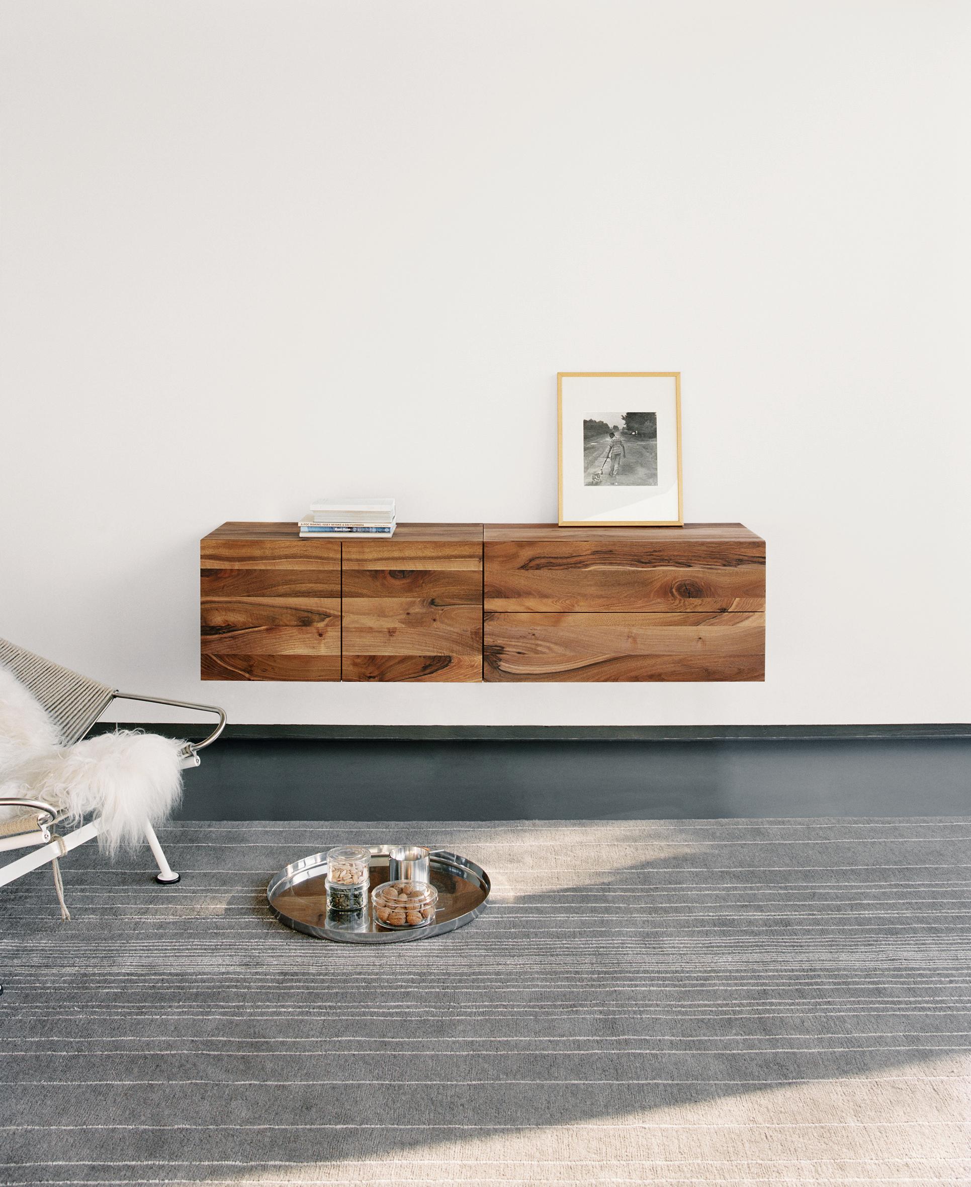 Chest of drawers Mahnaz is the wall-mounted adaption of the sideboard Fatima. Even its body is made of solid wood, the sideboard floats effortlessly. The clear design of Mahnaz benefits from a concept that eliminates visible frames and excludes all