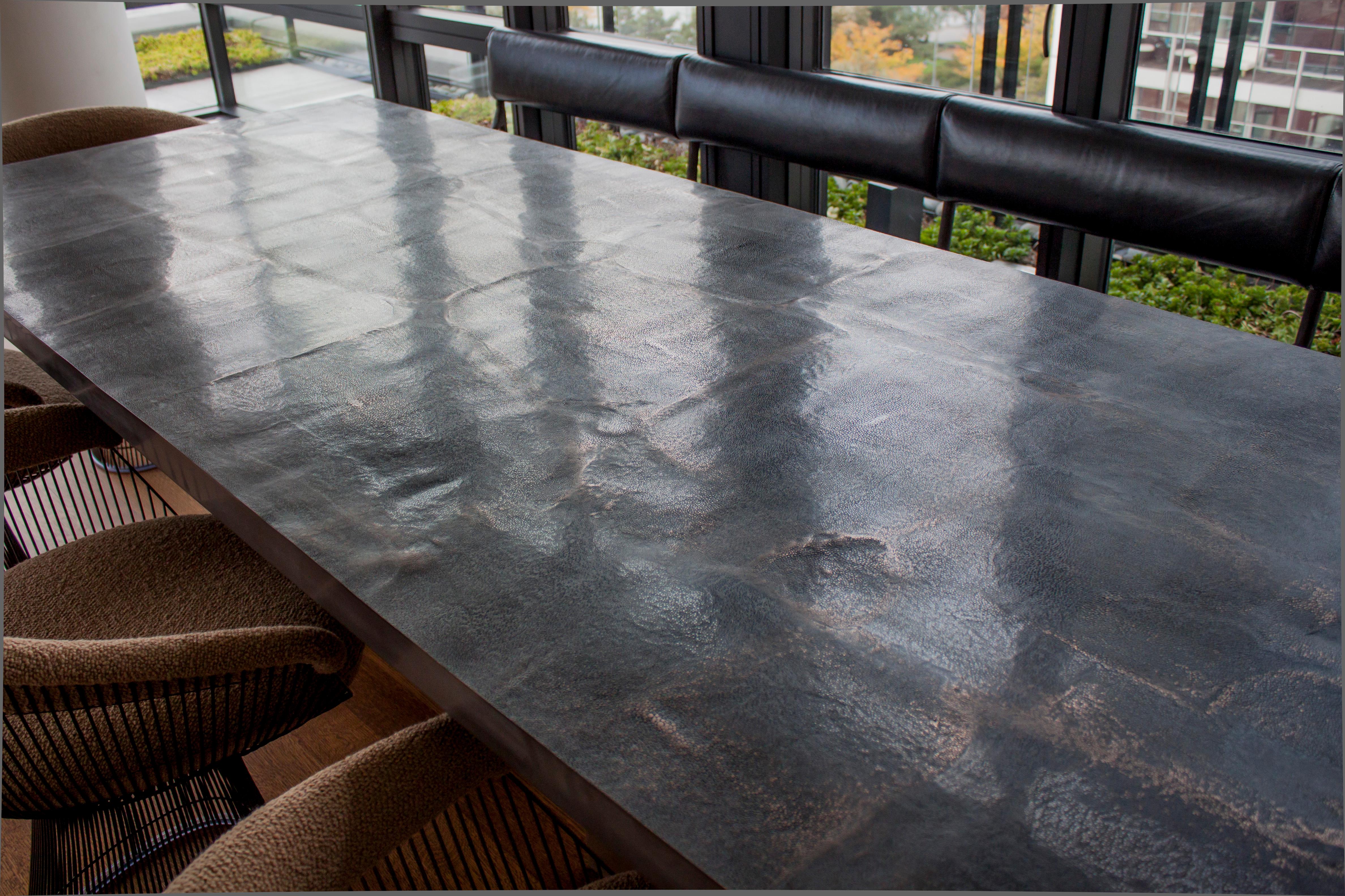 Abound with surface detail of the polished micro-pebble texture and the very gentle undulating waves of the table surface itself, this table will continue to fascinate you and inspire the best company and cuisine. From afar one notices the