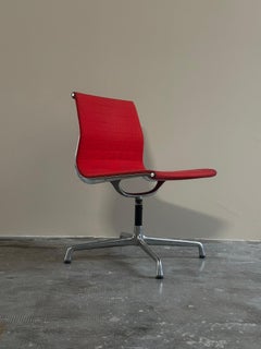 EA105 chair, by Charles Eames for ICF, 1960s with swivel seat and red fabric
