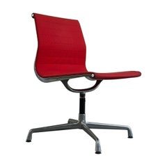 EA105 chair, by Charles Eames for ICF, 1960s with swivel seat and red fabric